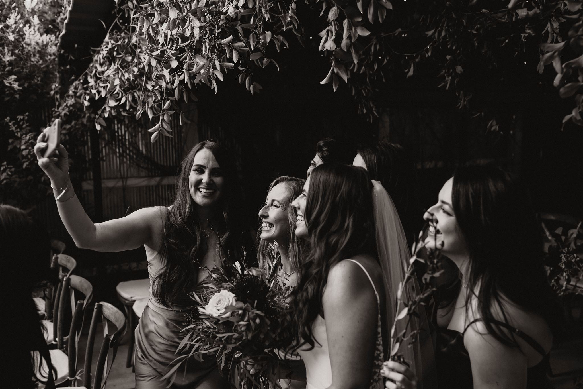 bride and guests smiling for a picture