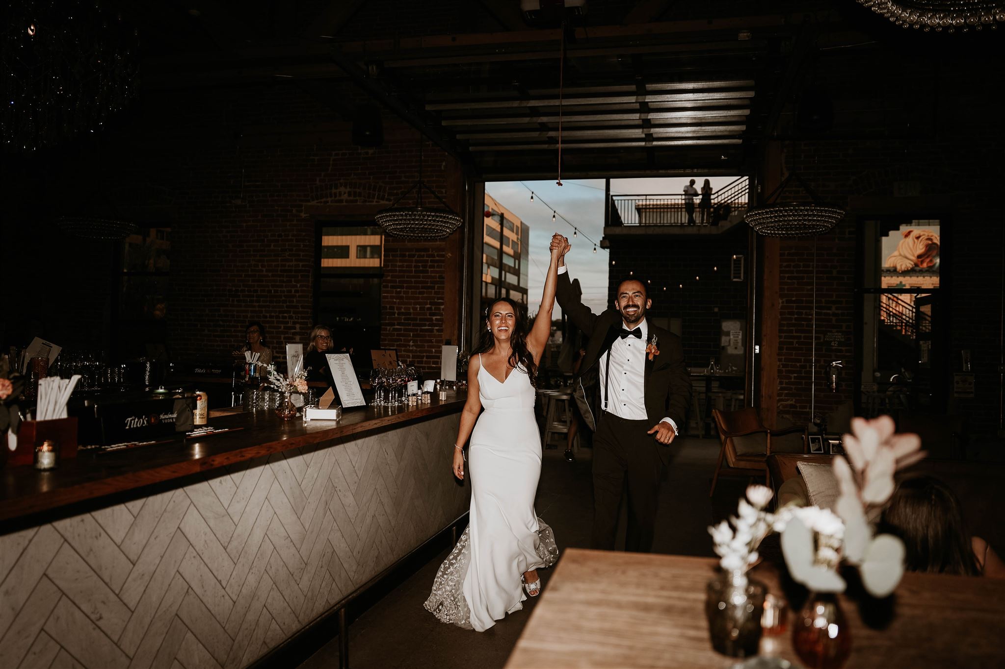 bride and groom walking into reception 