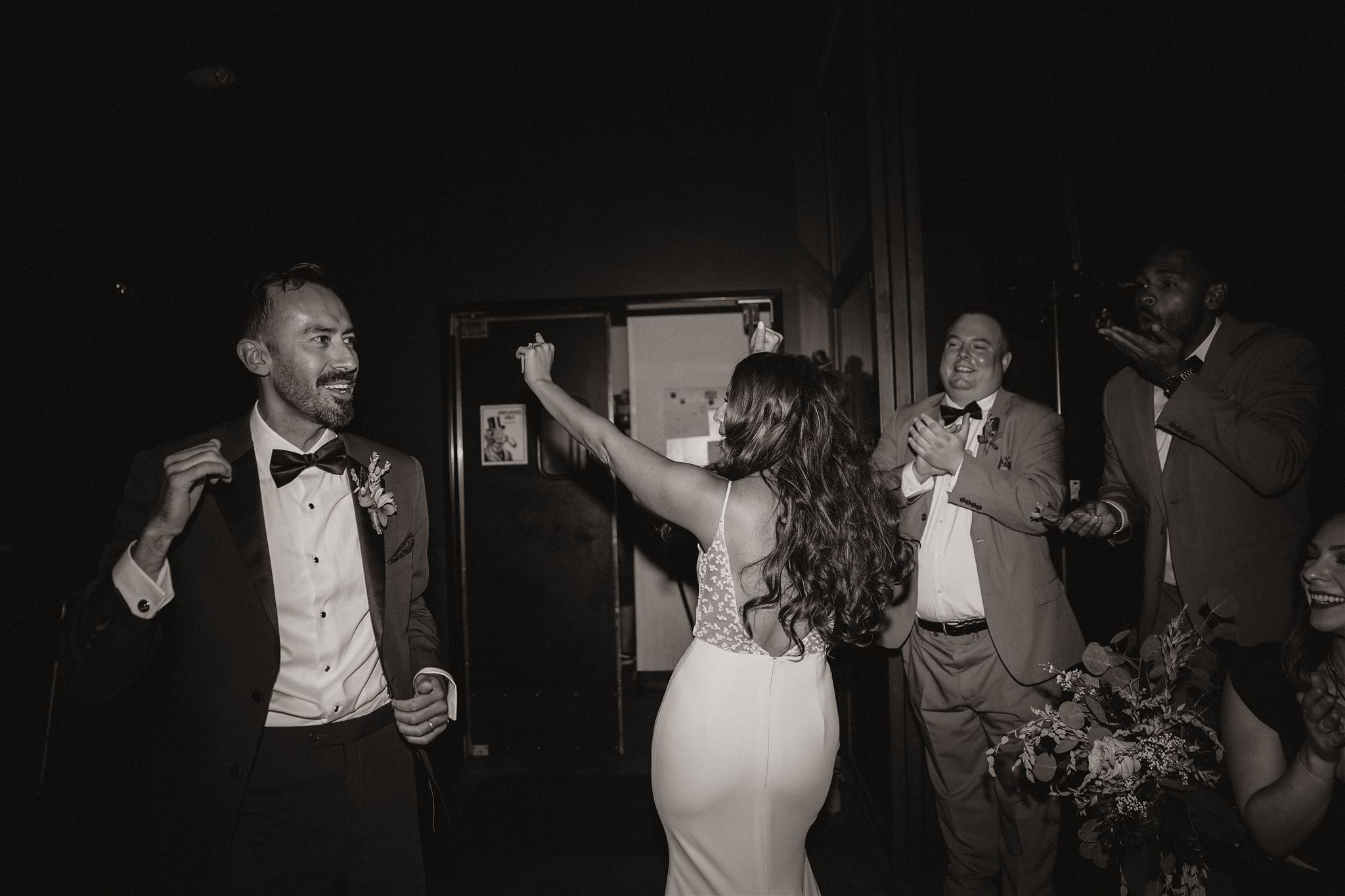 black and white of bride dancing 
