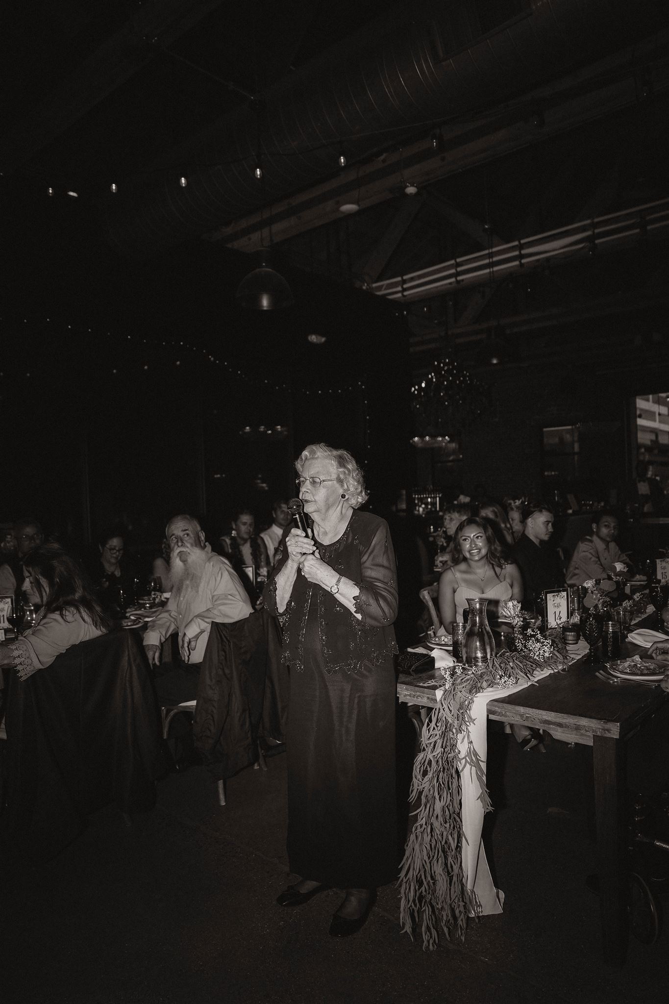 black and white of grandma giving a speech at fall wedding in colorado 