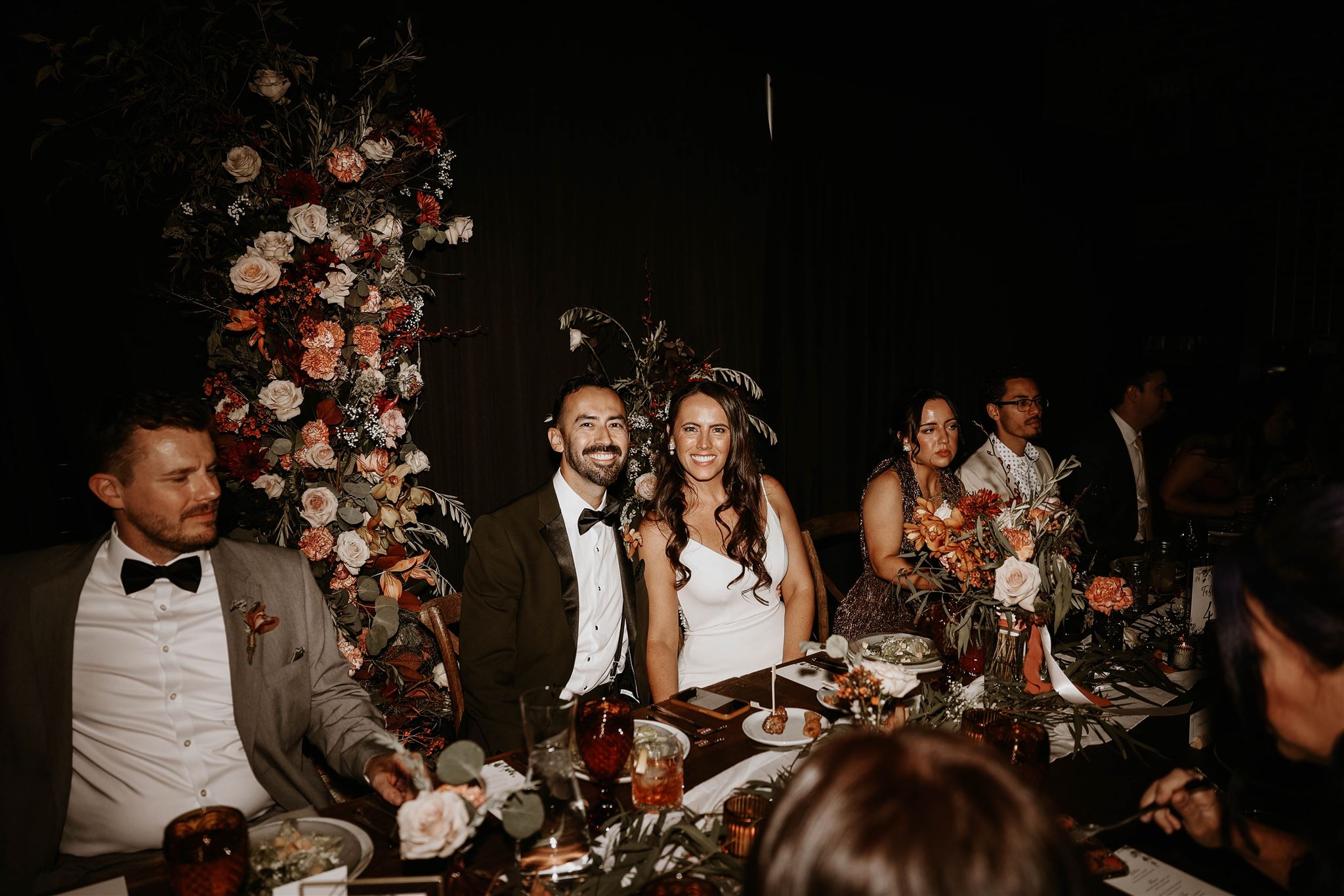 bride and groom at floral head table at fall wedding in colorado 