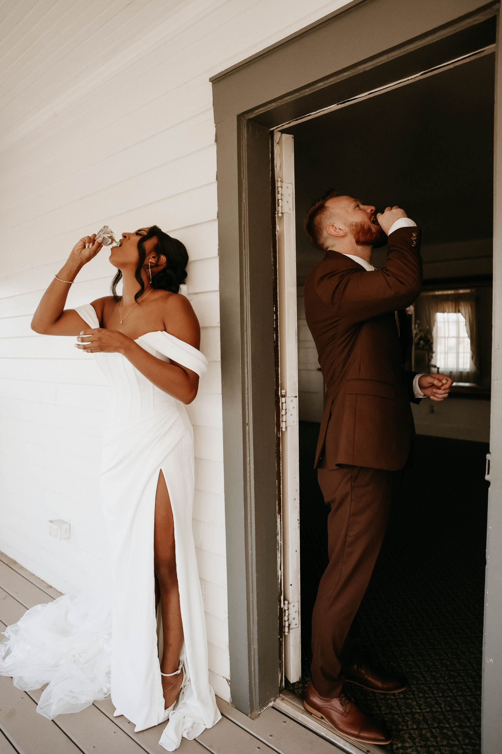 bride and groom taking a shot together without looking at eachother before ceremony 