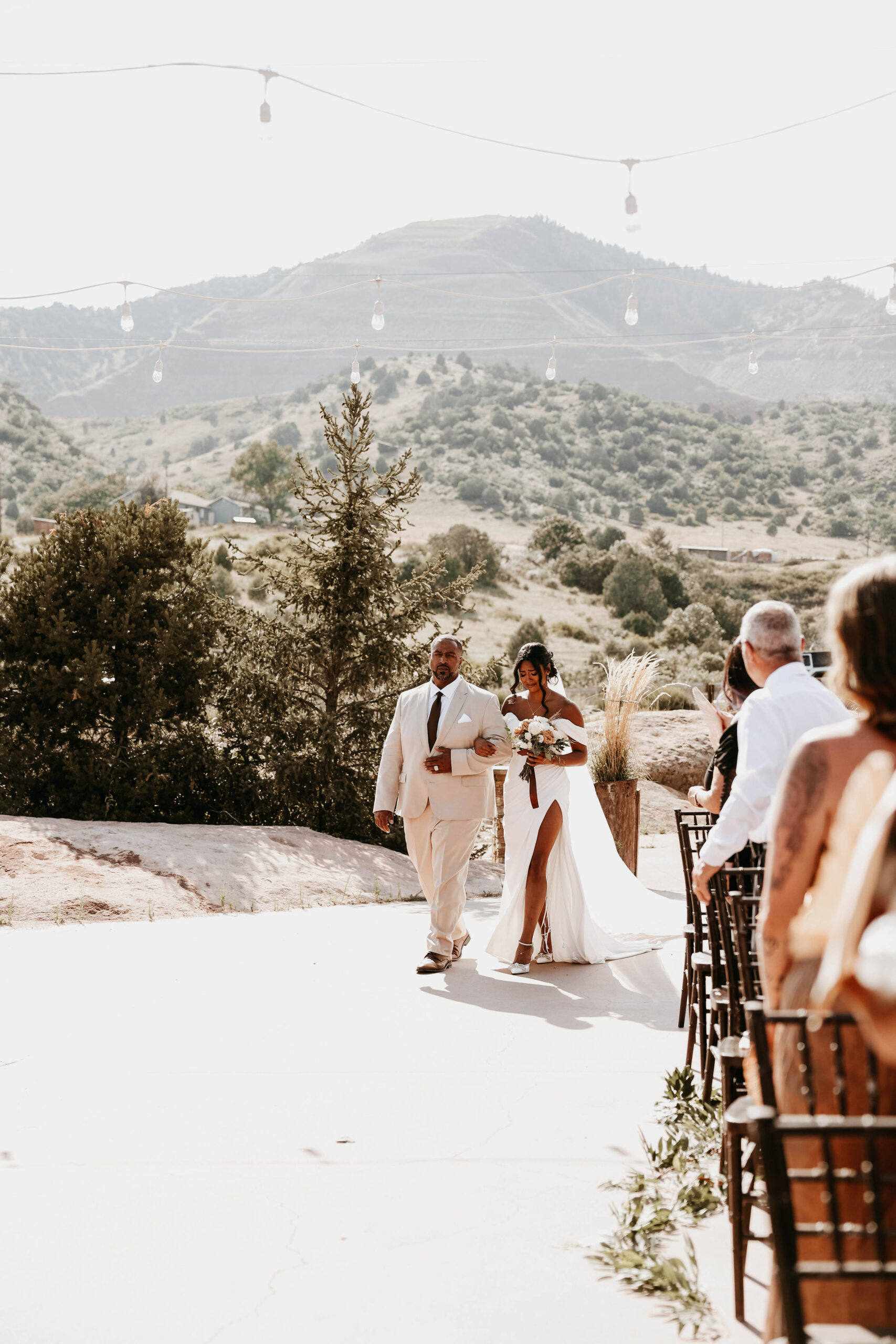 bride and her father walking down aisle at outdoor wedding in Colorado