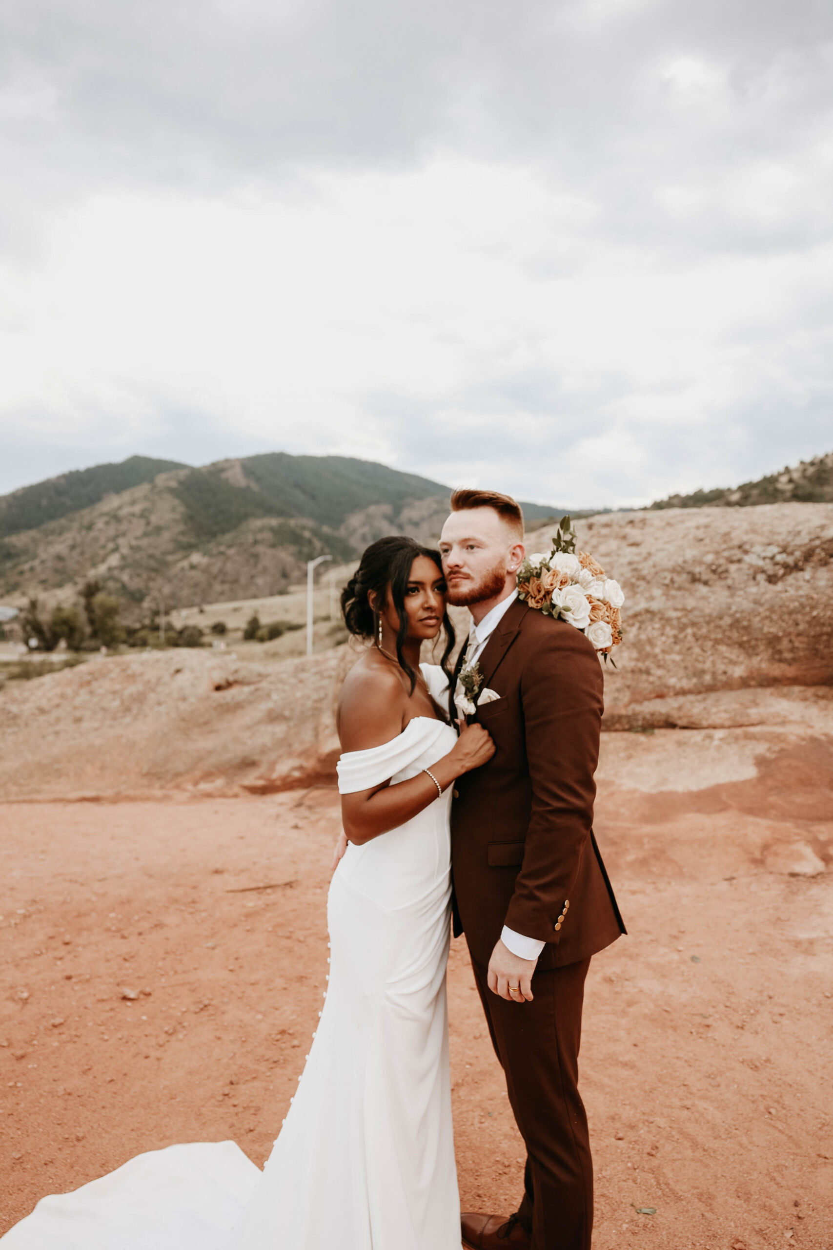 bridal couple holding each other and posing at outdoor wedding in Colorado