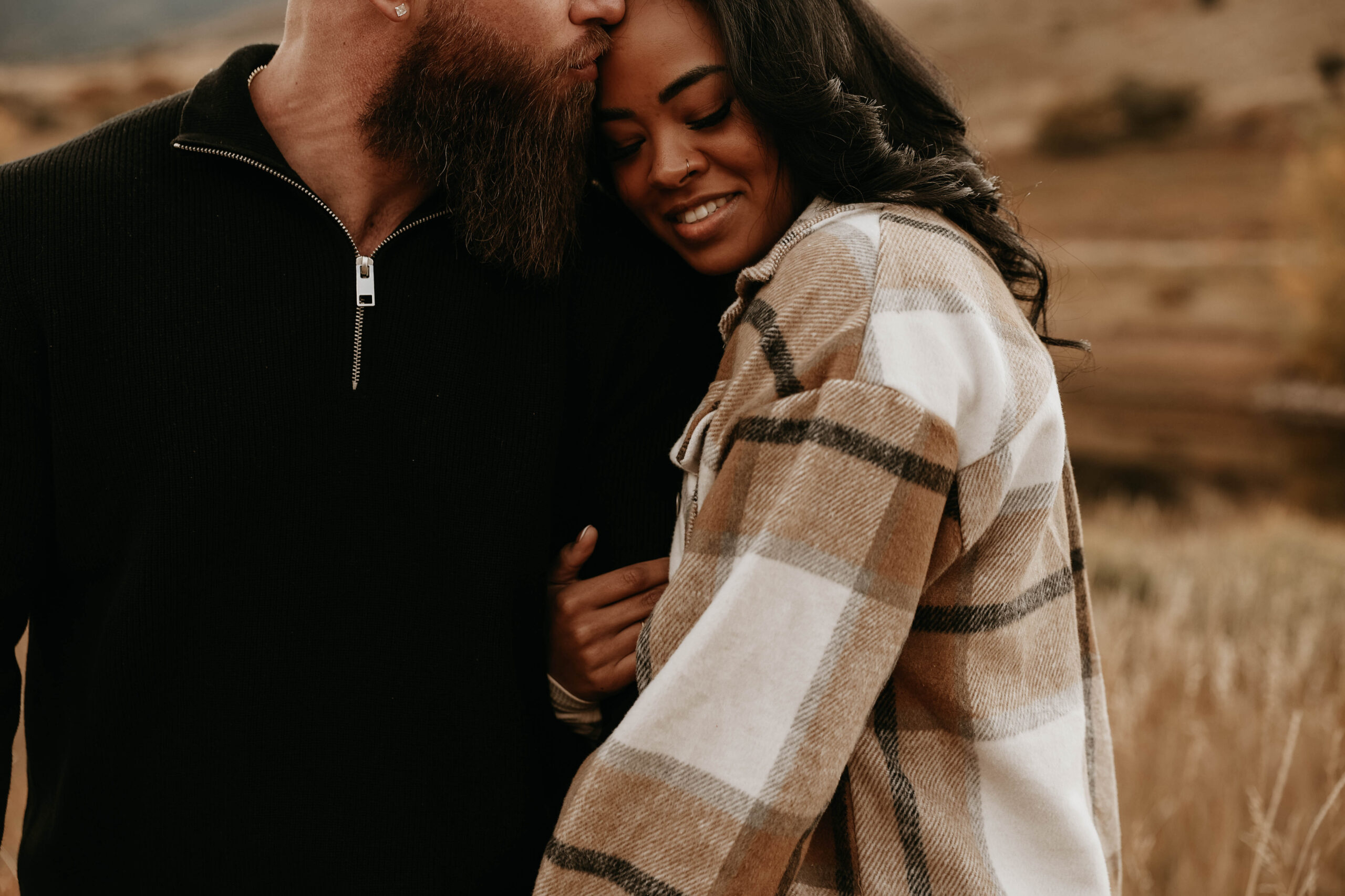 finace kissing other fiance's forehead at colorado engagement session