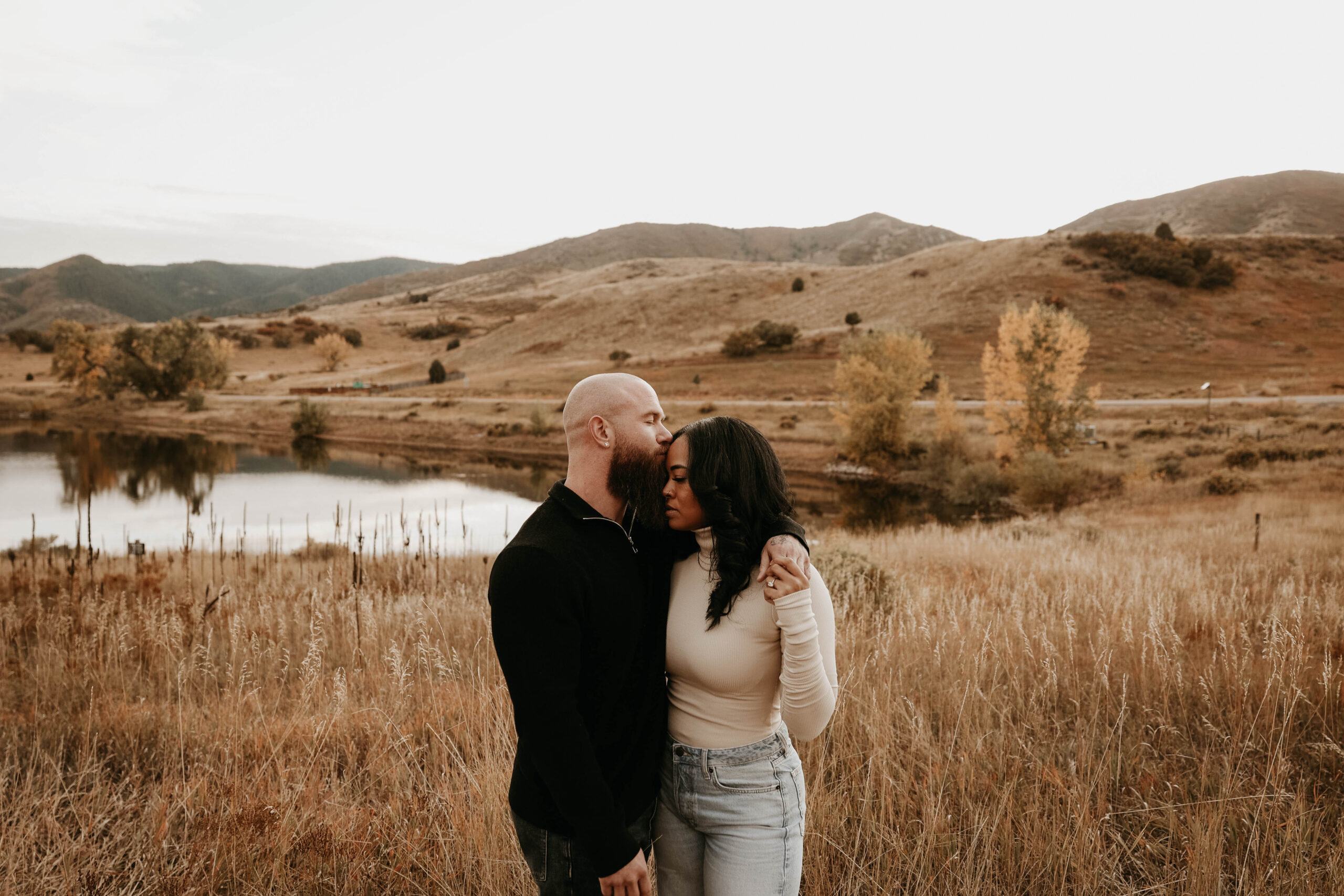 fiance kissing fiance on the forehead during fall colorado engagement session