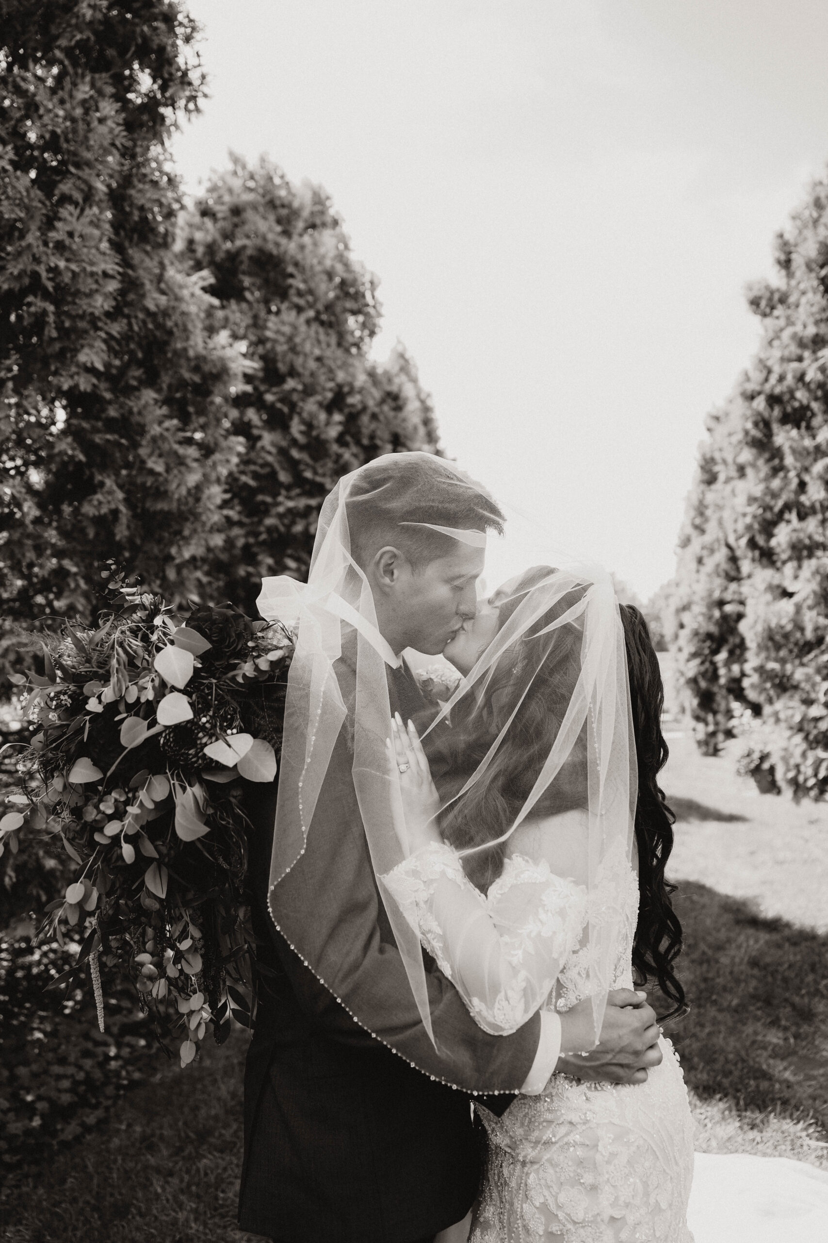 black and white of veil wedding couple portraits at romantic denver botanic gardens