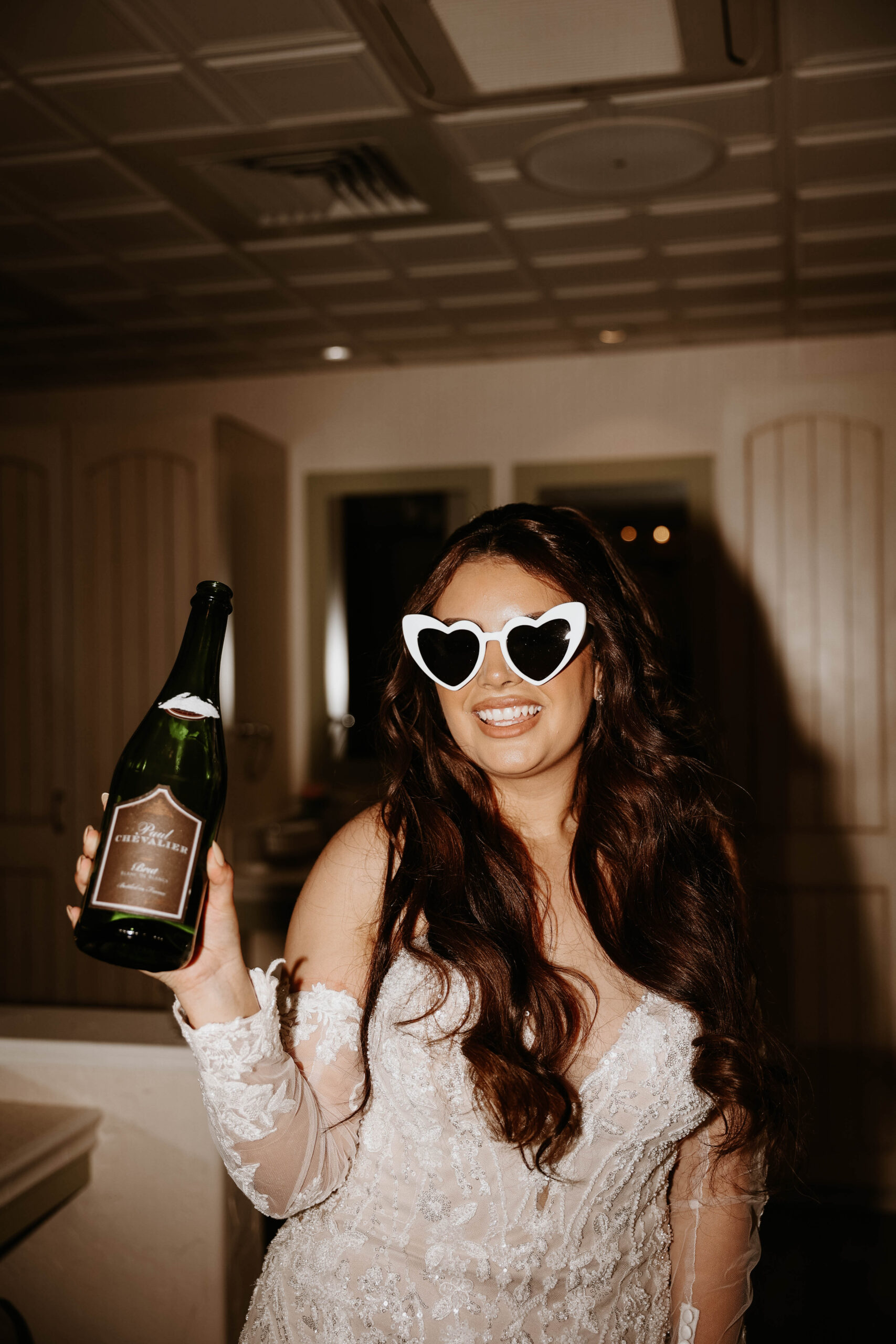 bride with heart glasses and a bottle of champagne 