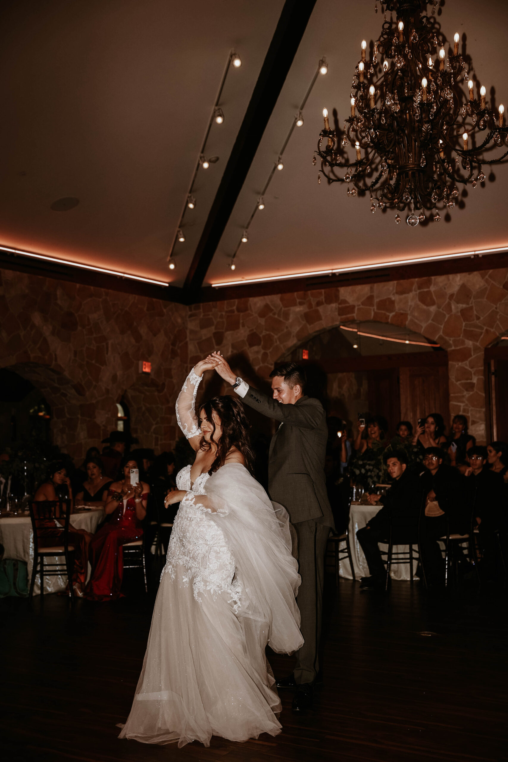 groom spinning bride during first dance 
