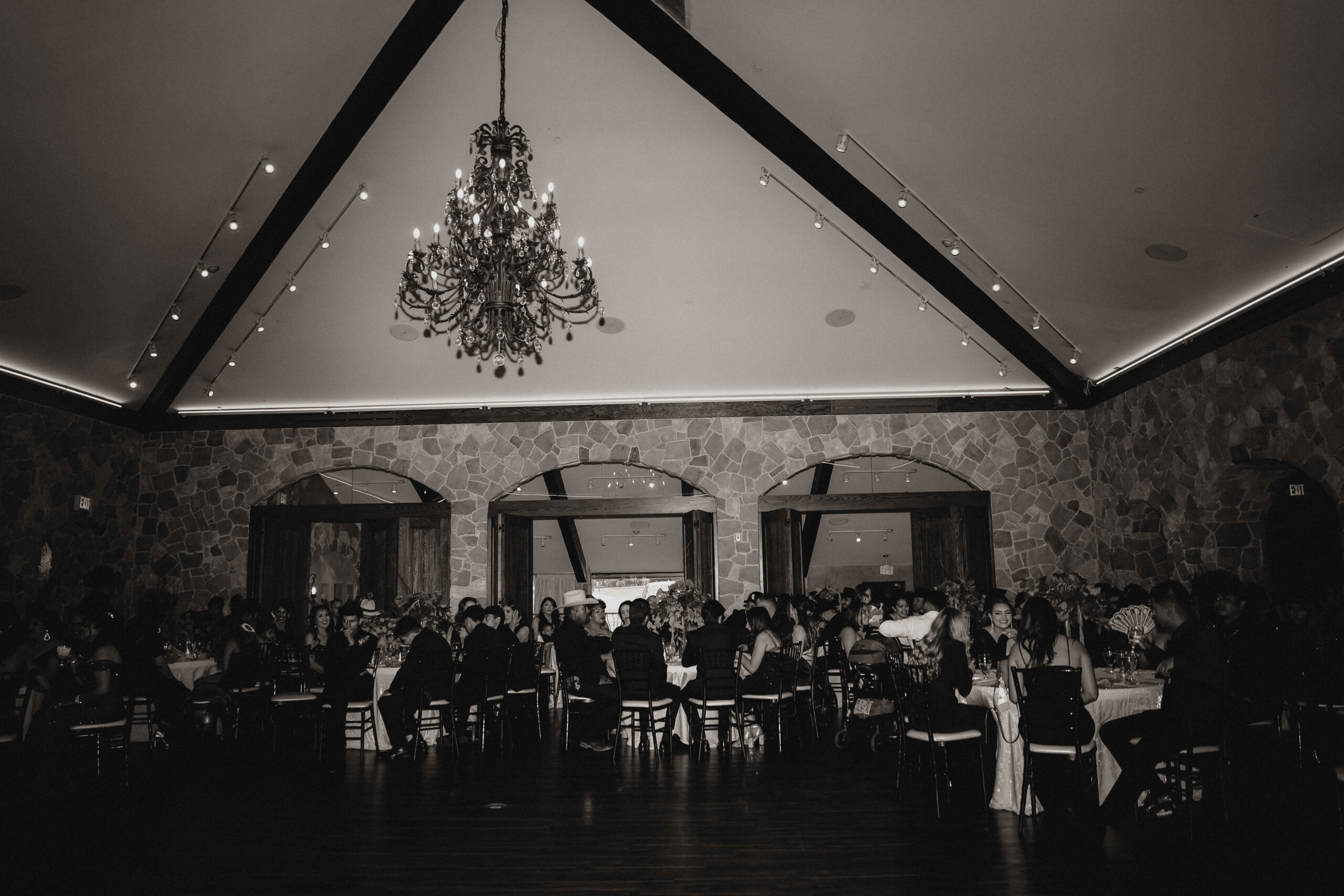black and white of wedding reception guests sitting at tables 