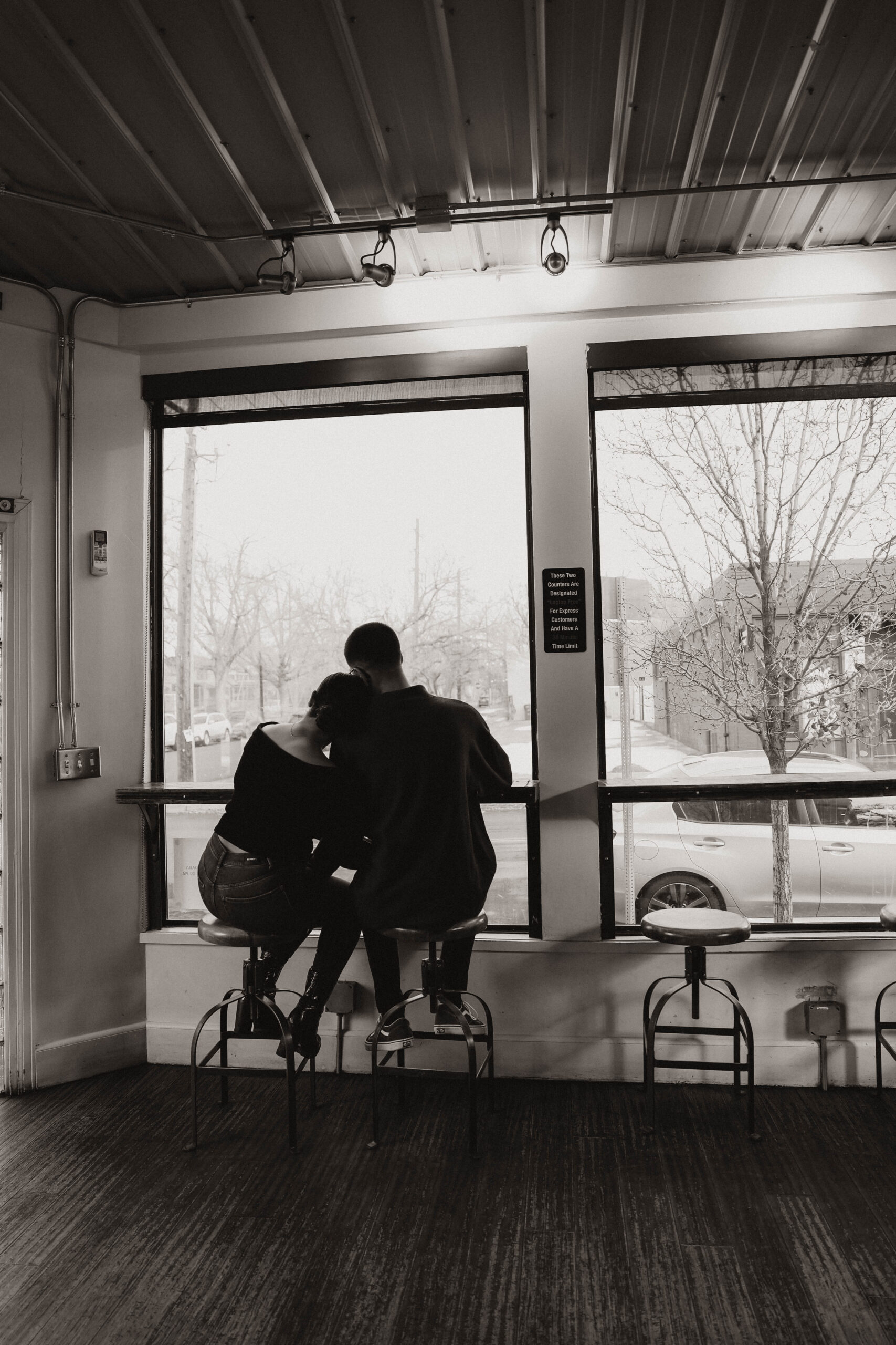 couple at steam espresso bar in denver, their engagement photo location