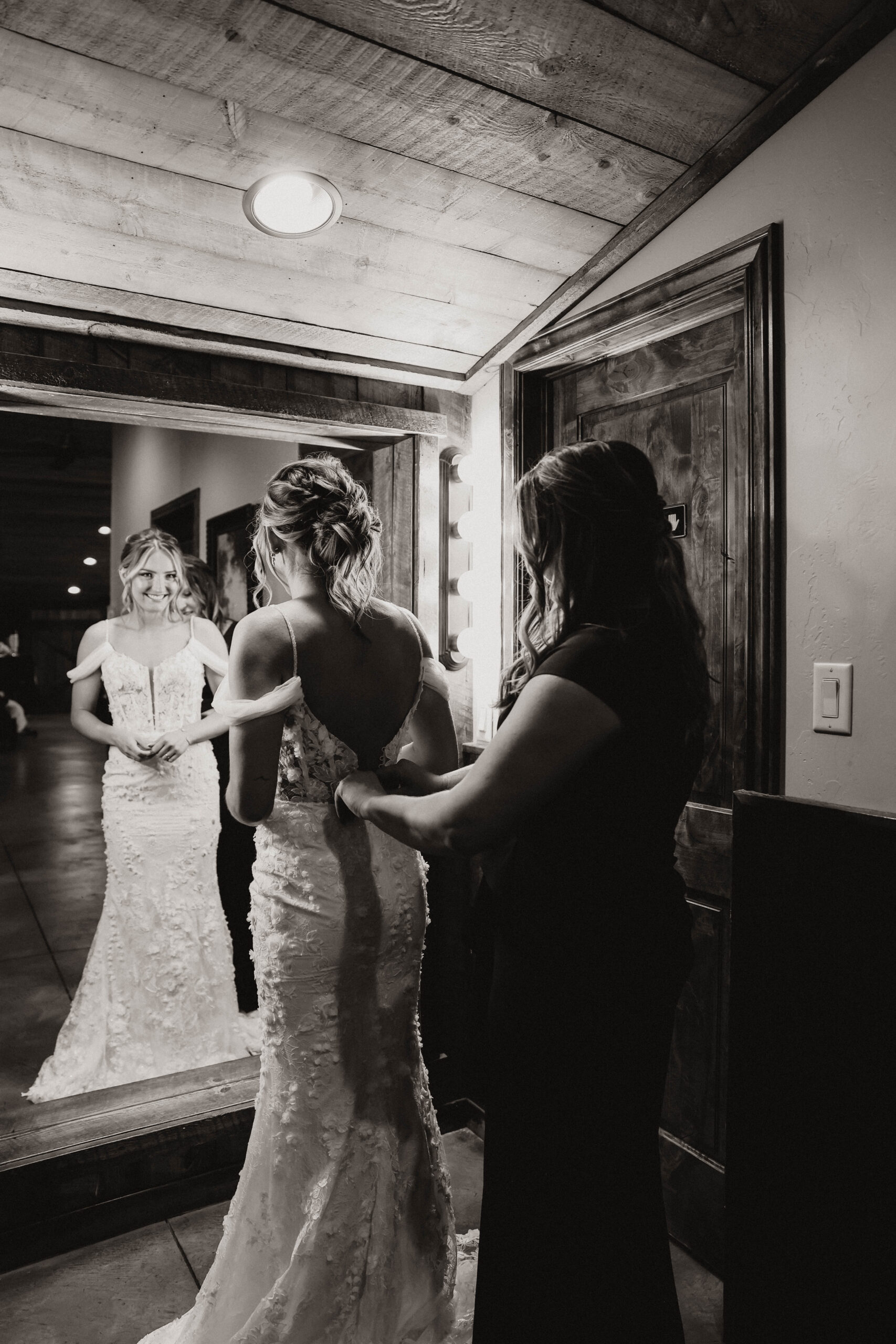 bride getting help with her dress