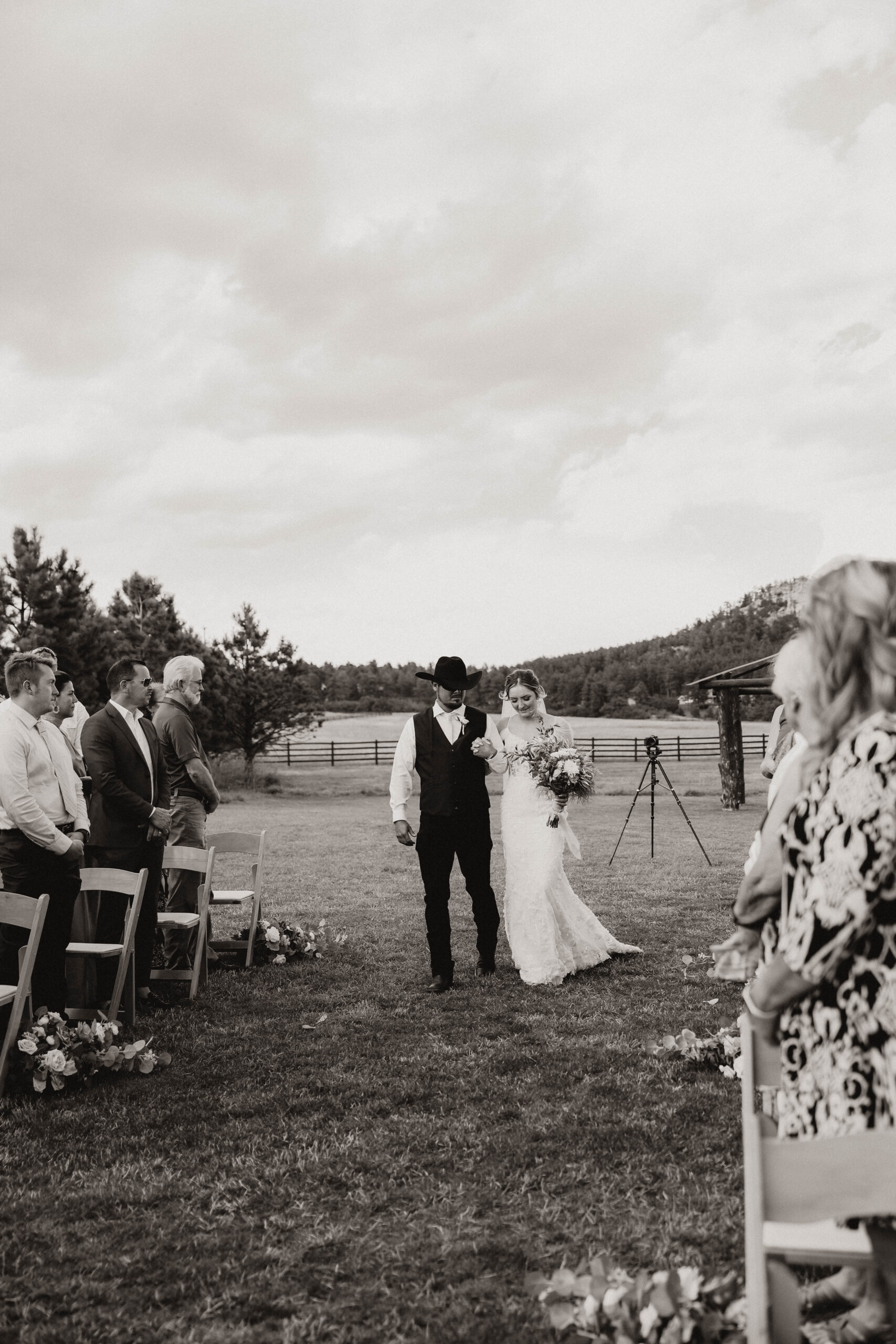 bride and her dad walking down the aisle at the Spruce Mountain Ranch Wedding 