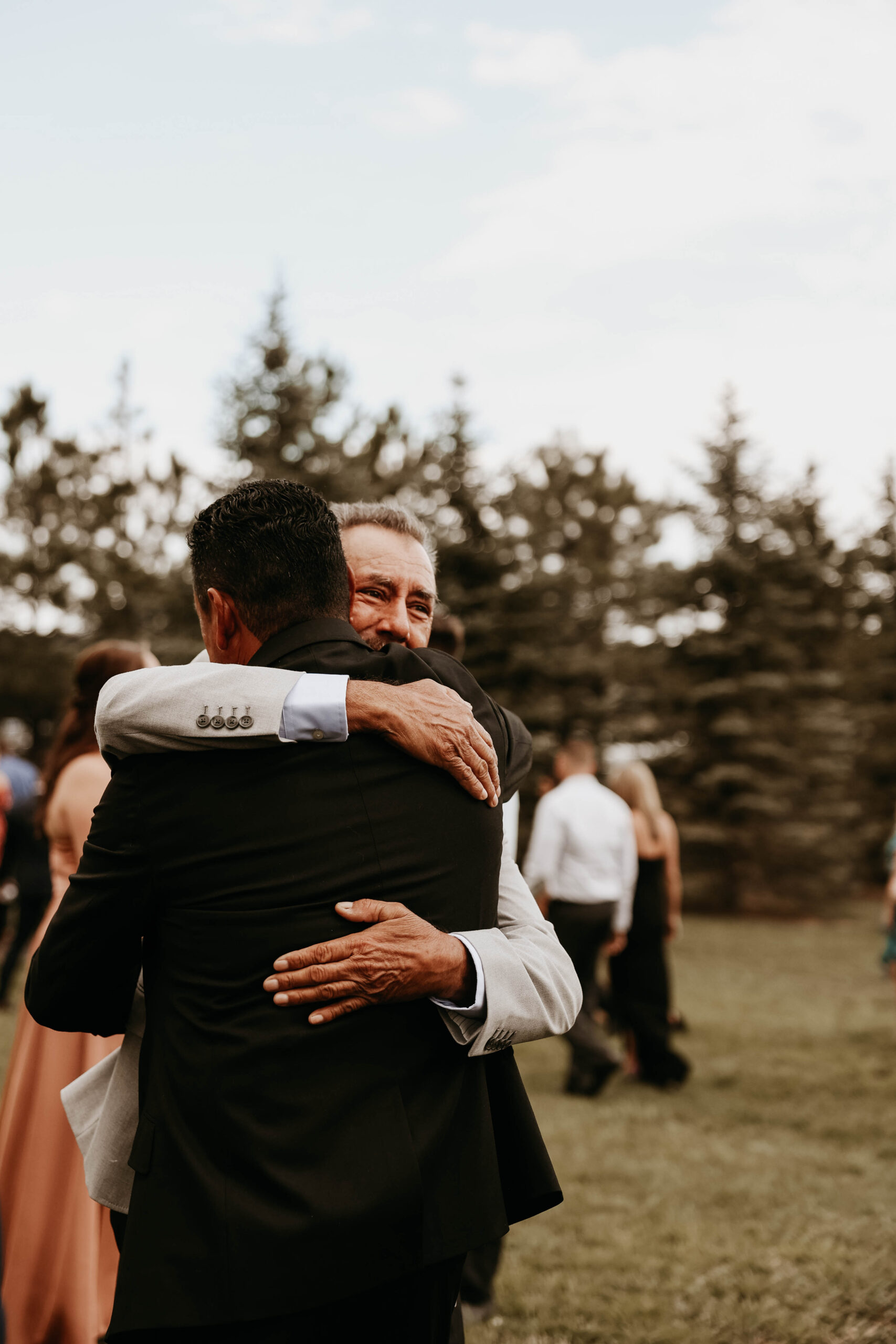 wedding guests hugging at Spruce Mountain Ranch Wedding 