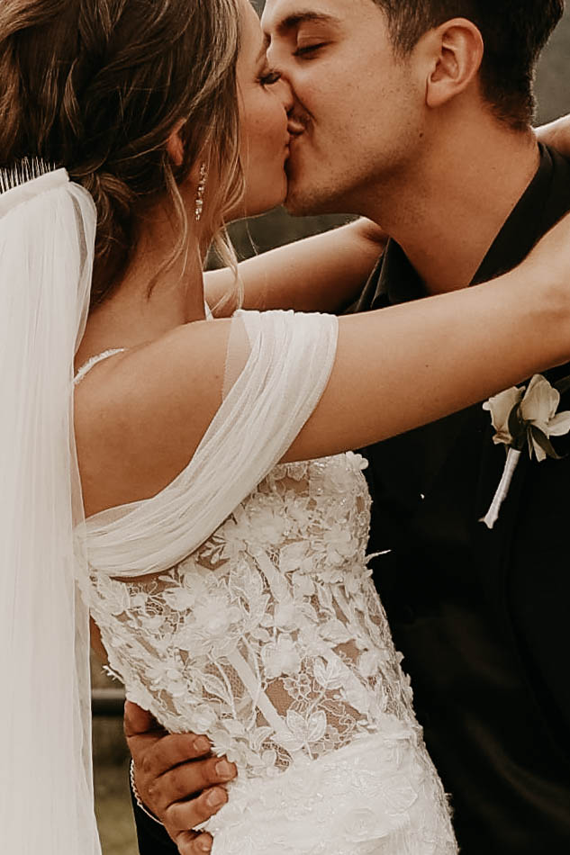 closeup of bridal couple kissing 