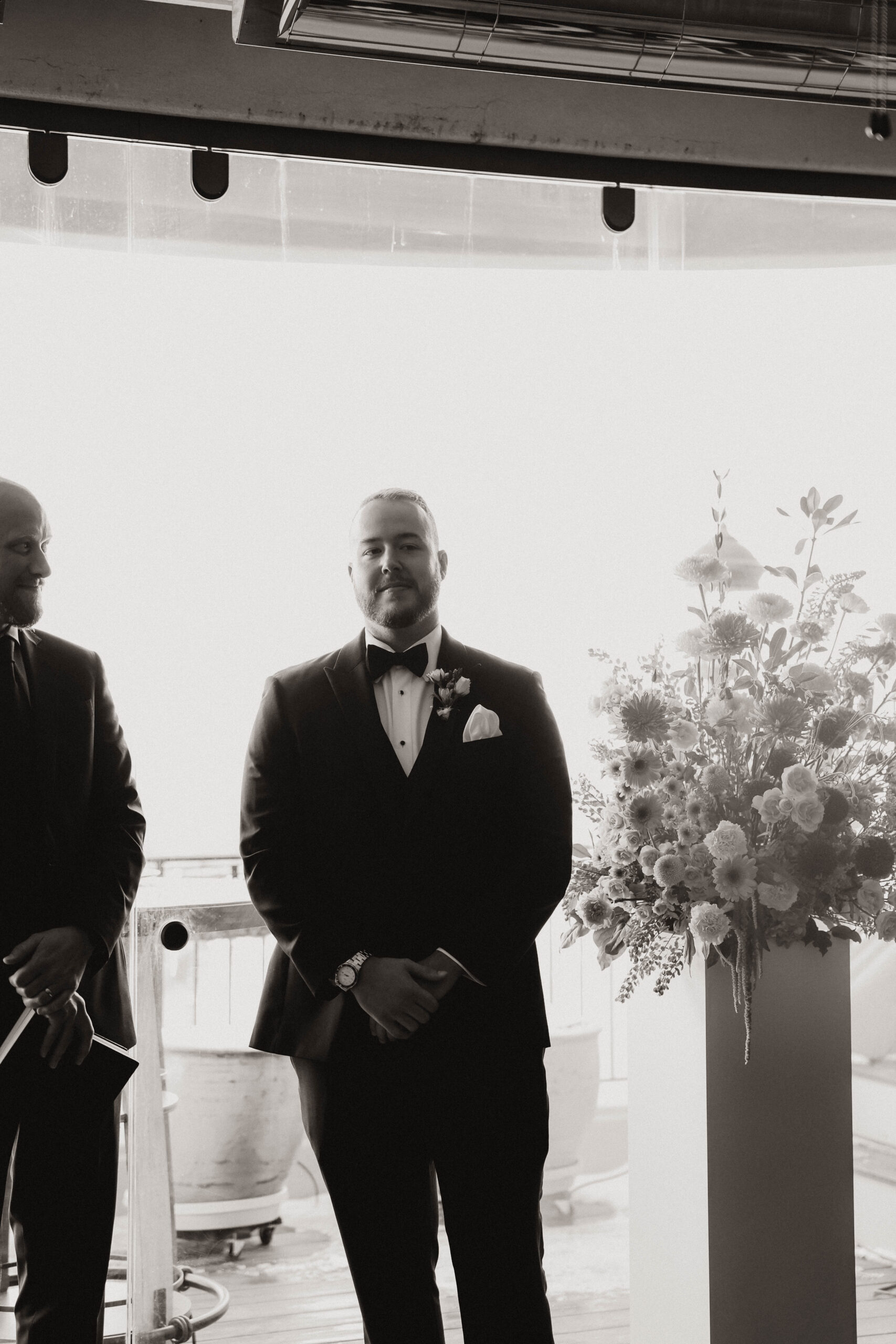 groom standing and smiling at the altar 