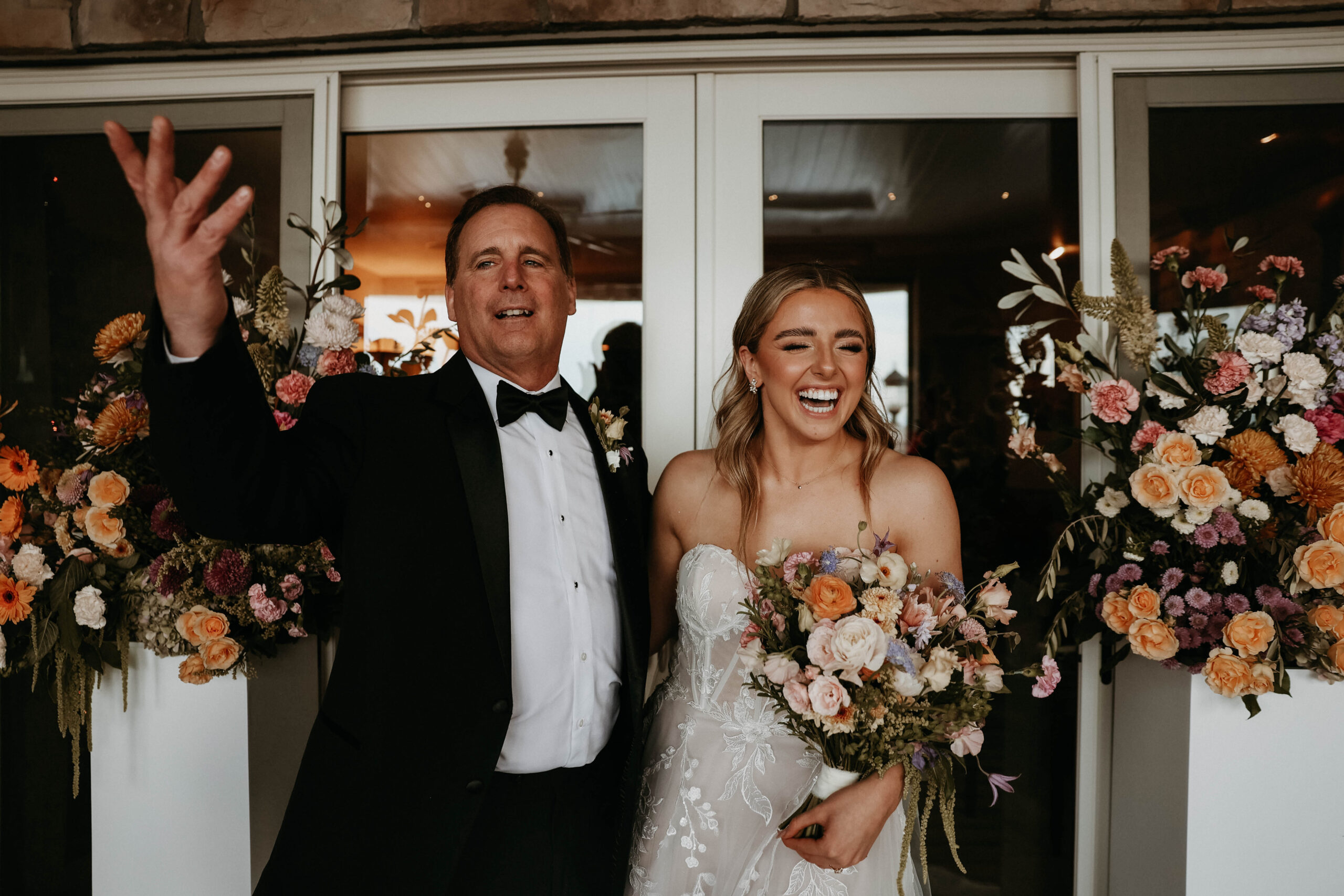 candid photo of bride and her dad laughing 