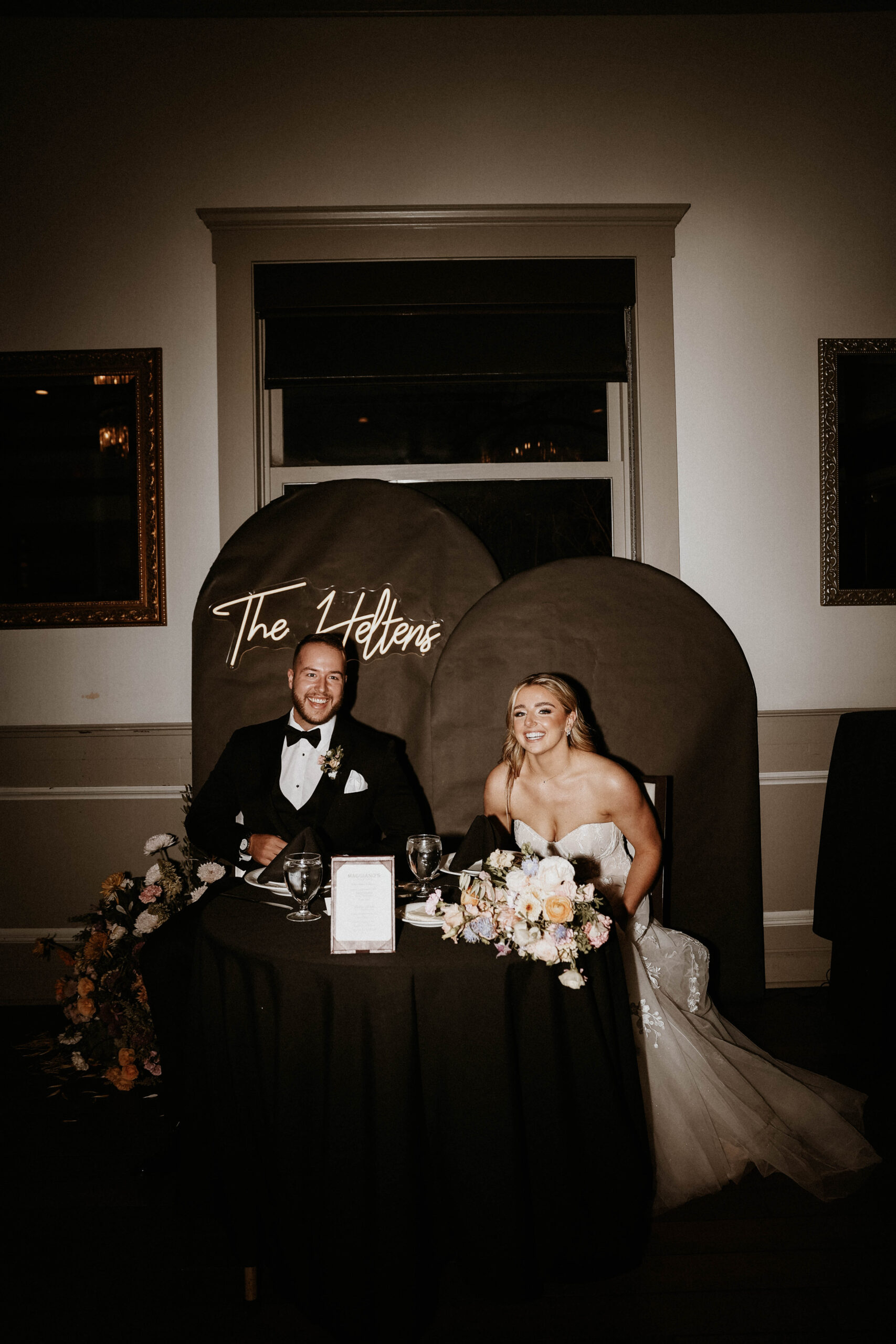 bridal couple sitting at their reception table 