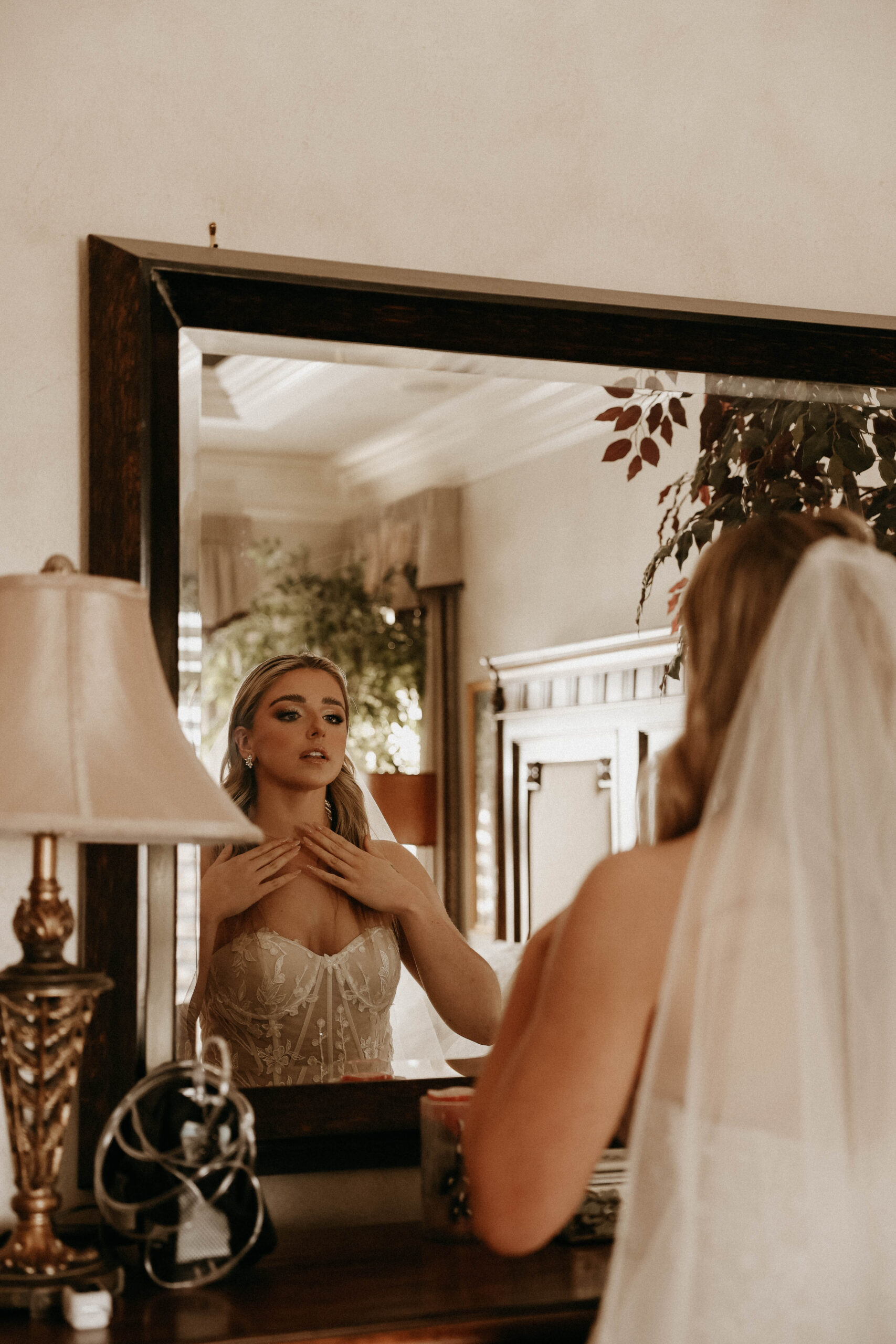 bride looking into the mirror while getting ready 