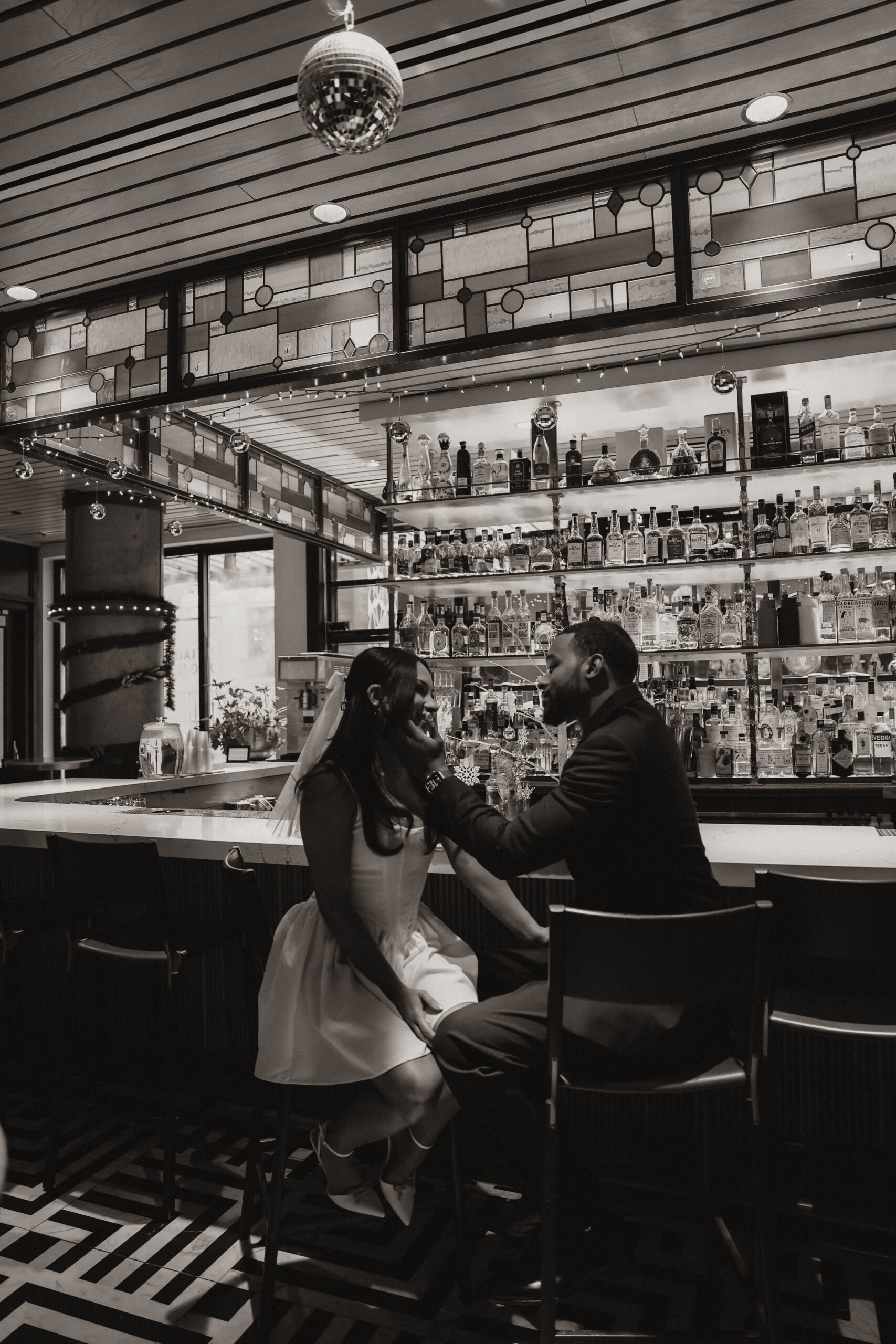 engaged couple sitting at a bar together during their engagement photos 