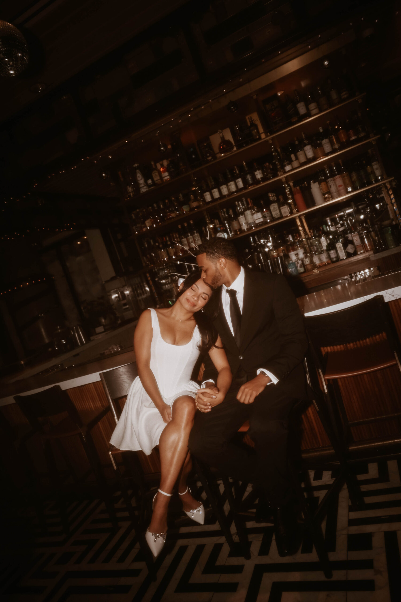 vintage looking photo of couple at the bar expressing their unique engagement shoot ideas