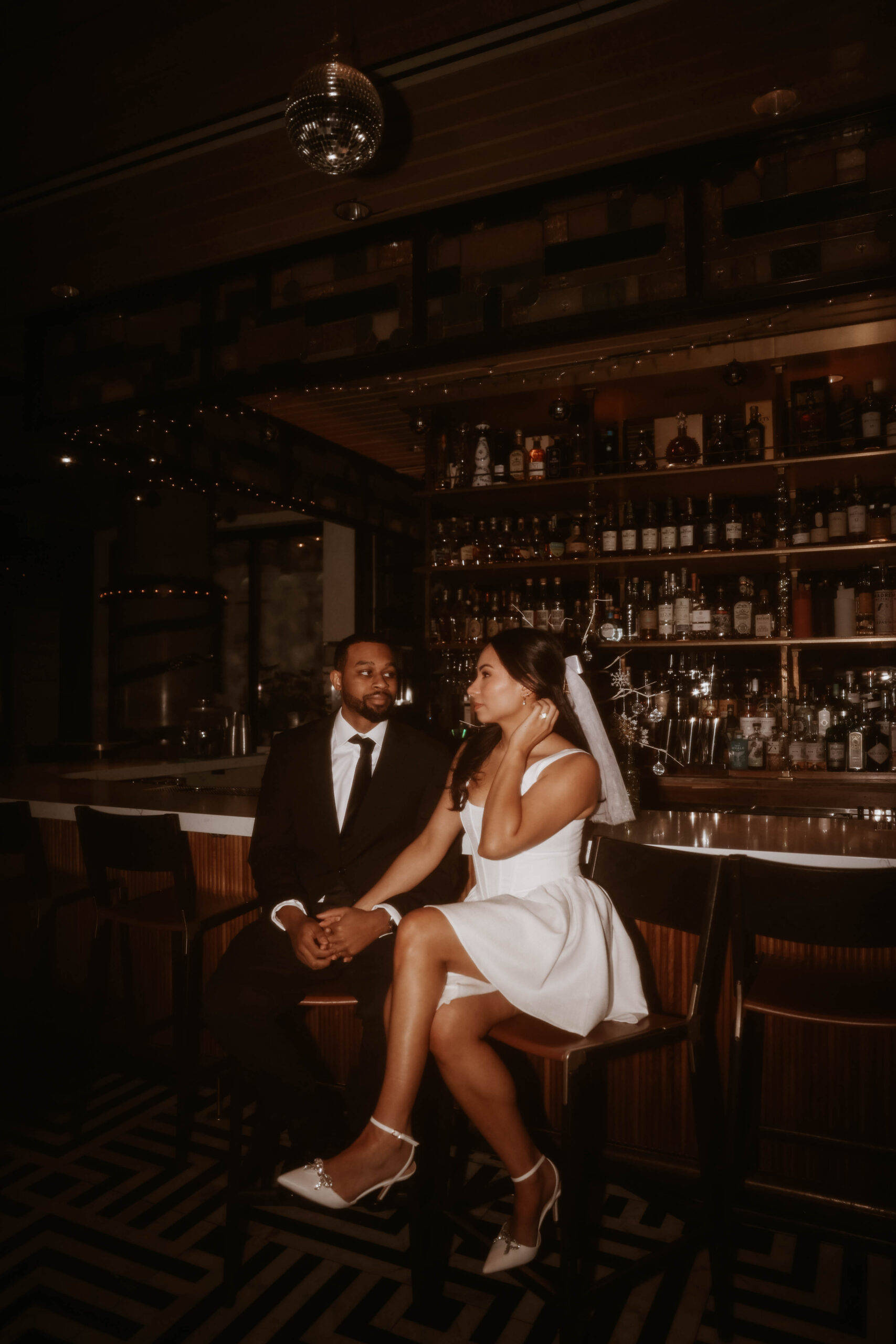 newly engaged couple taking their unique engagement shoot ideas and making it reality for a bar engagement shoot