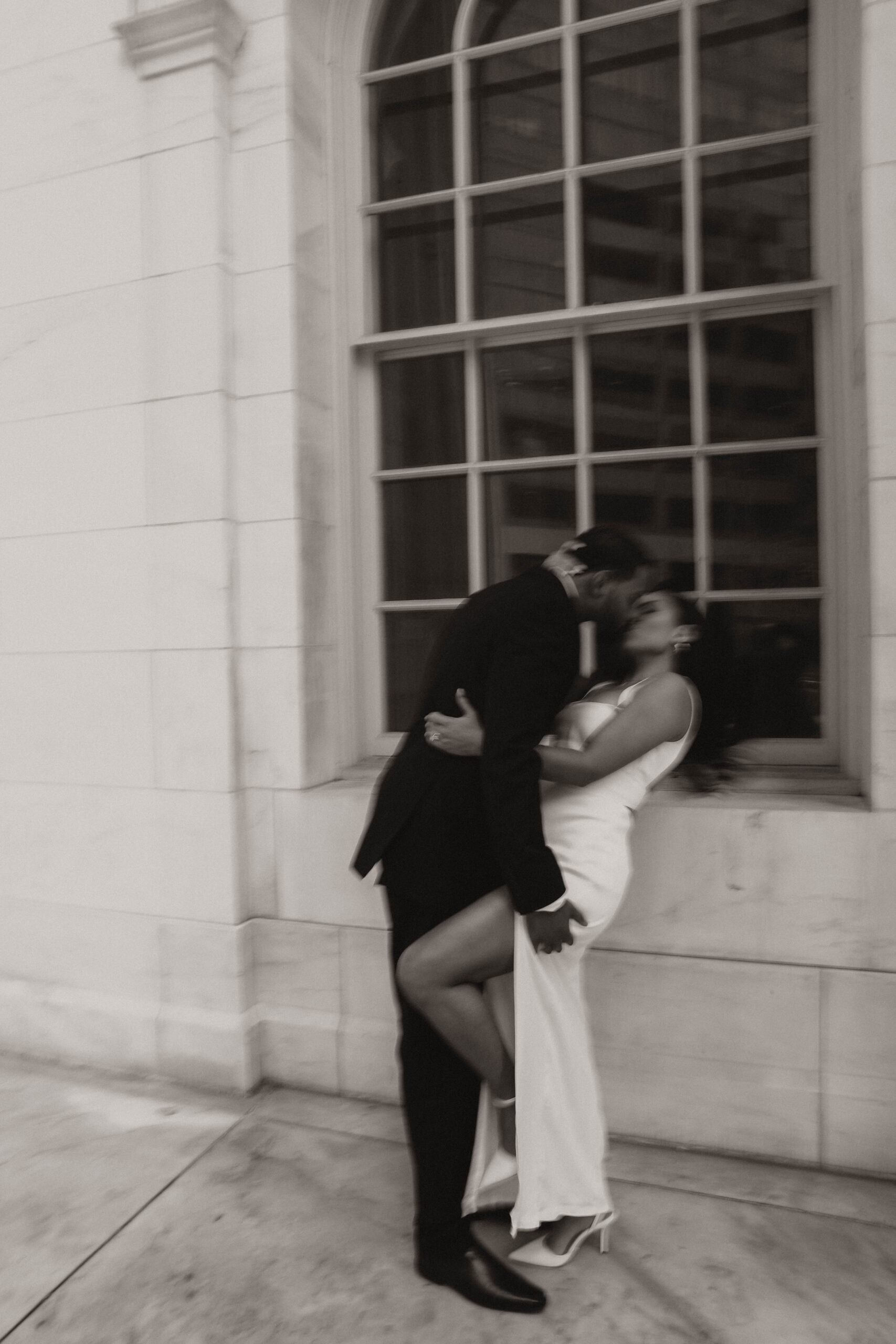 blurry photo of newly engaged couple kissing 