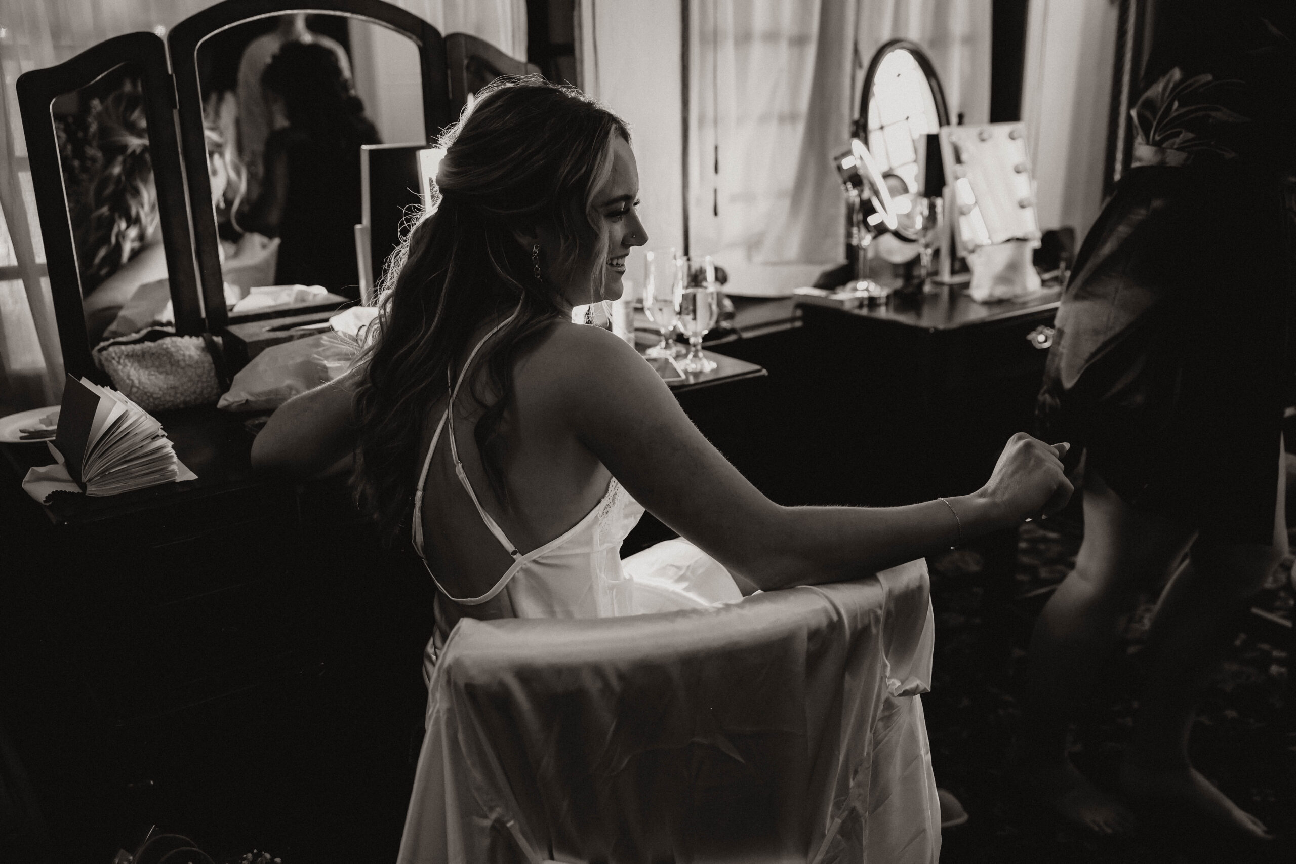 candid of bride sitting while she is getting ready 