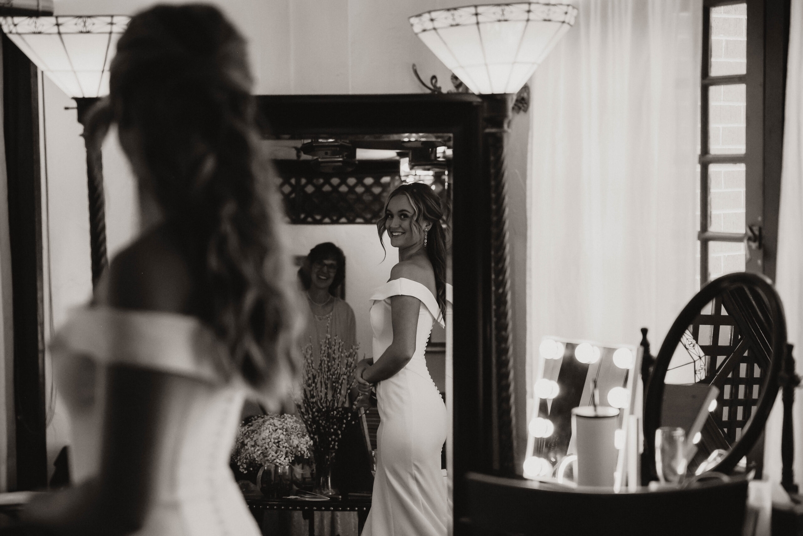 bride smiling at herself in the mirror