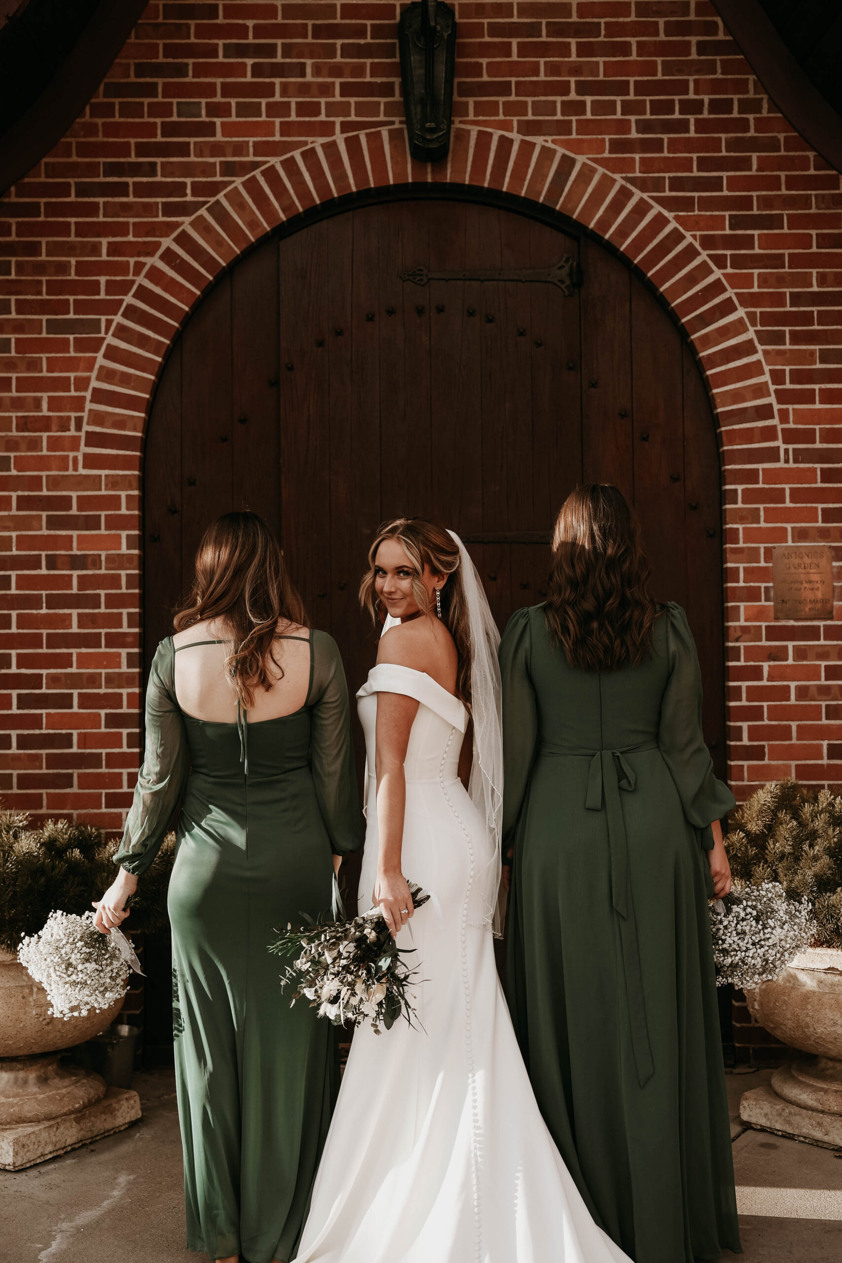 bride looking back while bridesmaids look ahead