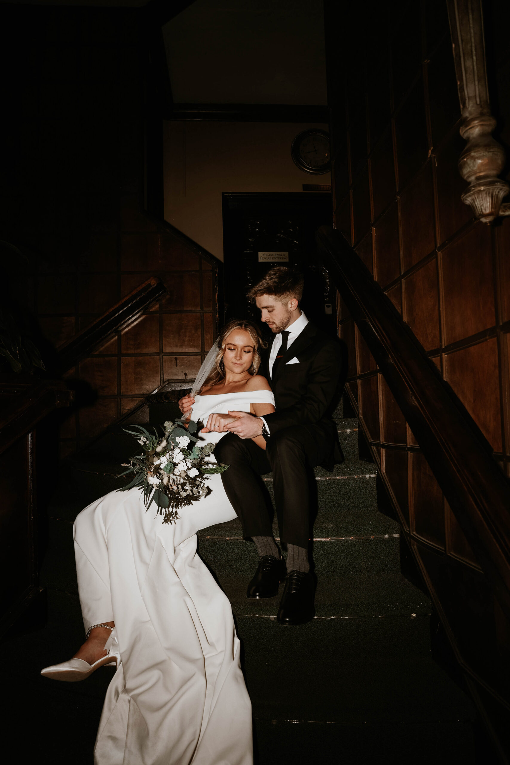 Wellshire Event Center Wedding couple sitting on the stairs together 