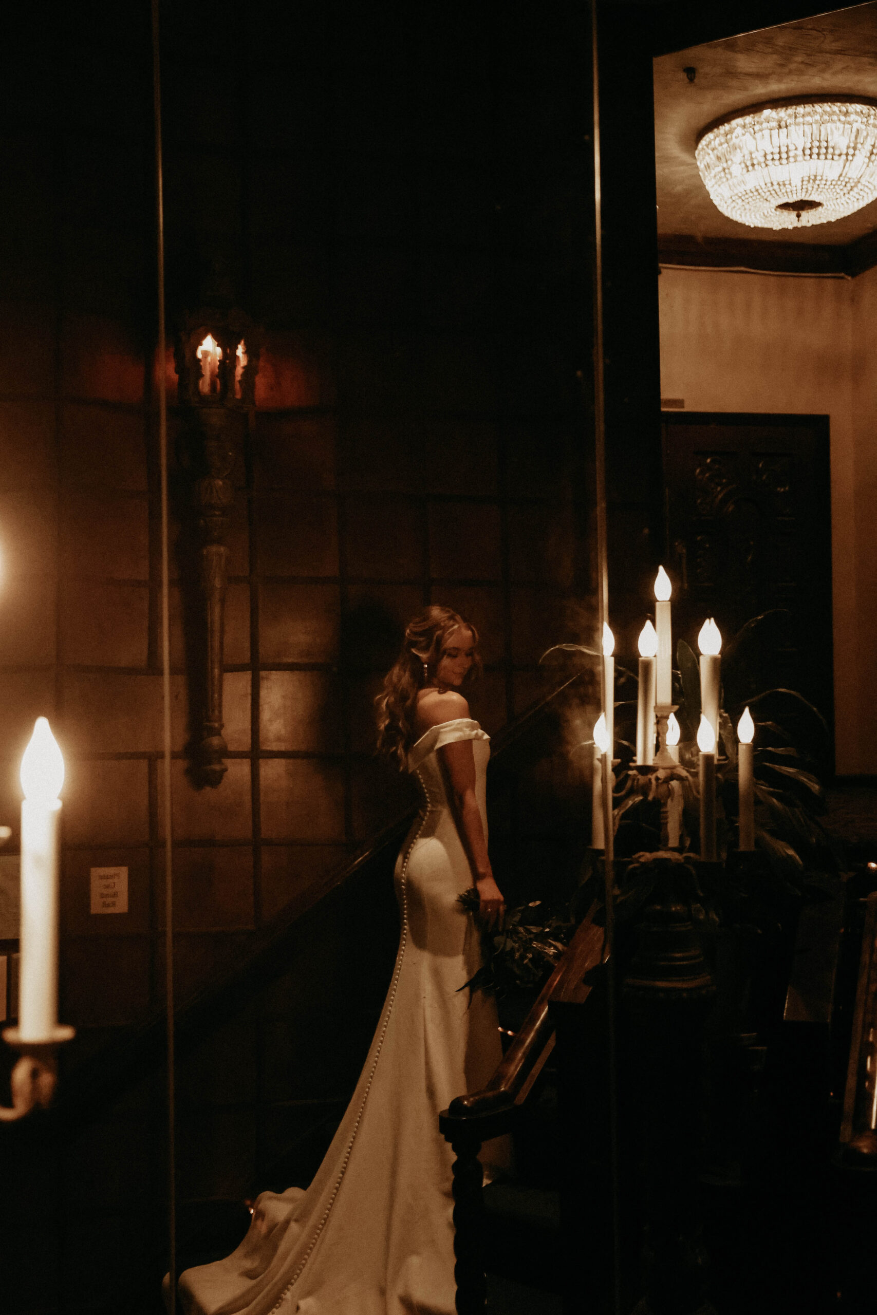 bridal portrait on the stairs with candle chandeliers 