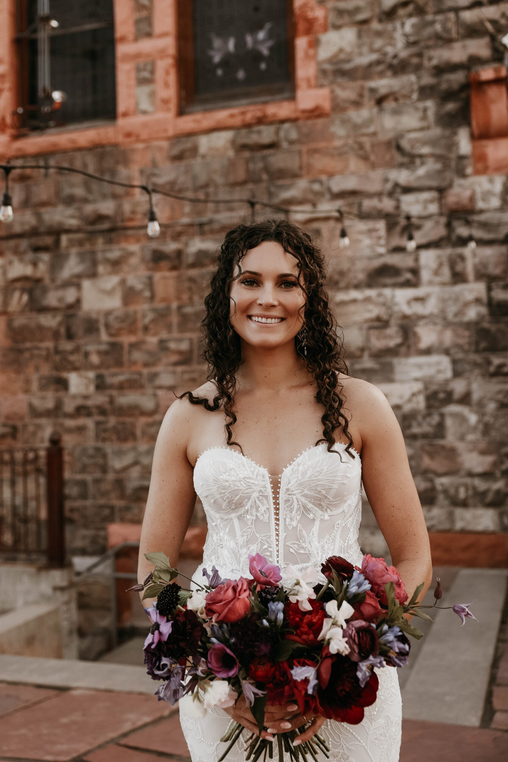 bride holding colorful wedding bouquet 