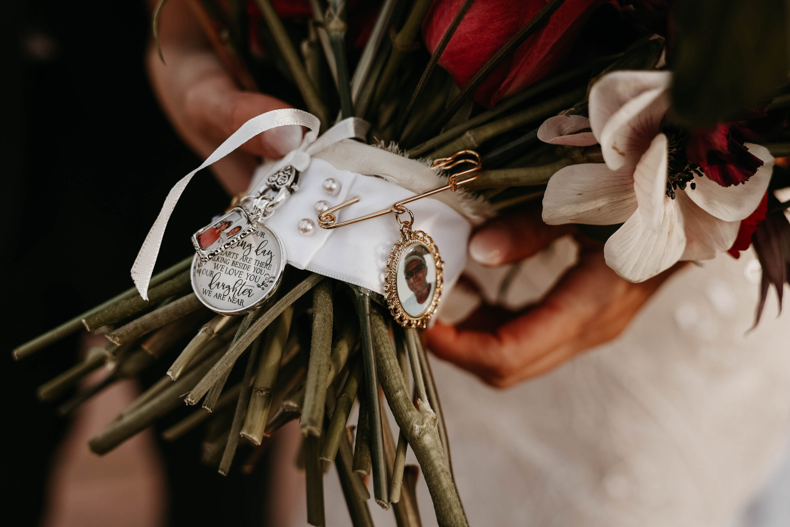 meaningful wedding touches of charms on brides bouquet 