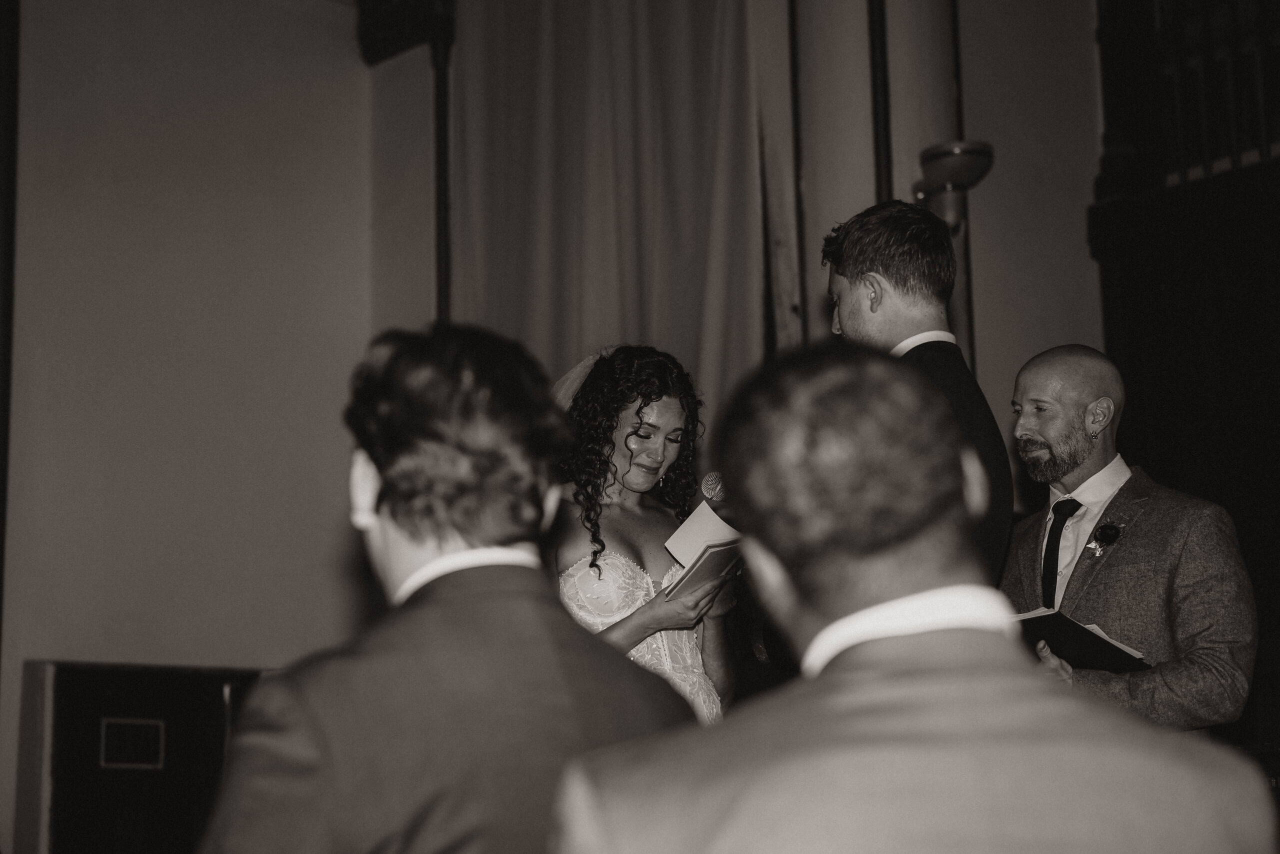 meaningful wedding moments of the bride tearing up as she reads her vows