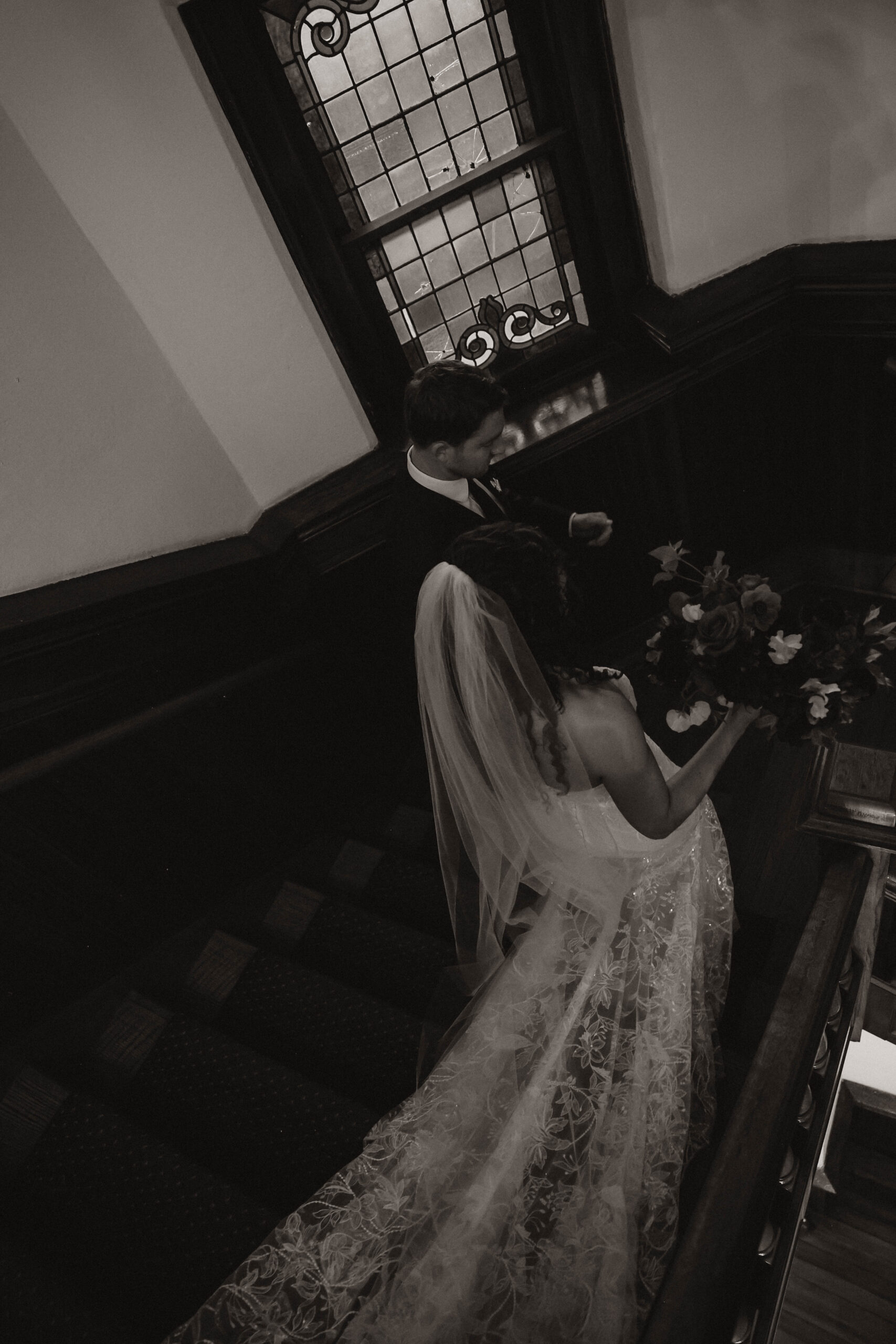 meaningful wedding moments of the bride and groom walking together down the stairs 