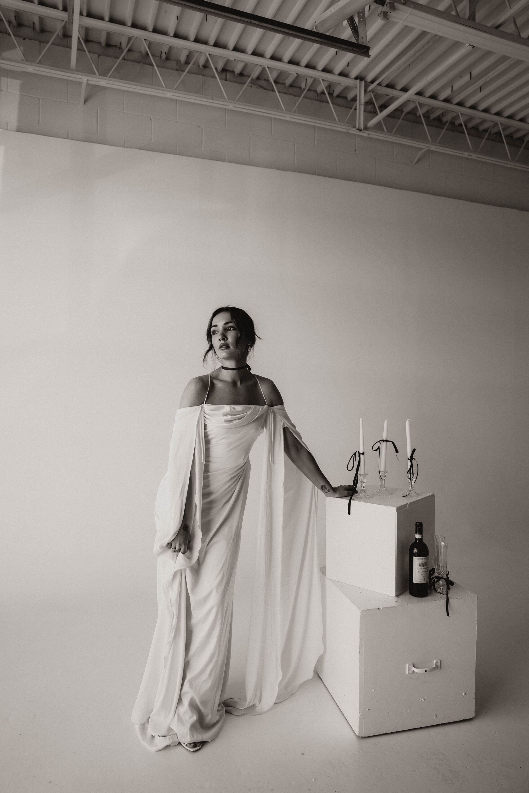 studio bridal photography portrait of bride leaning on prop boxes 
