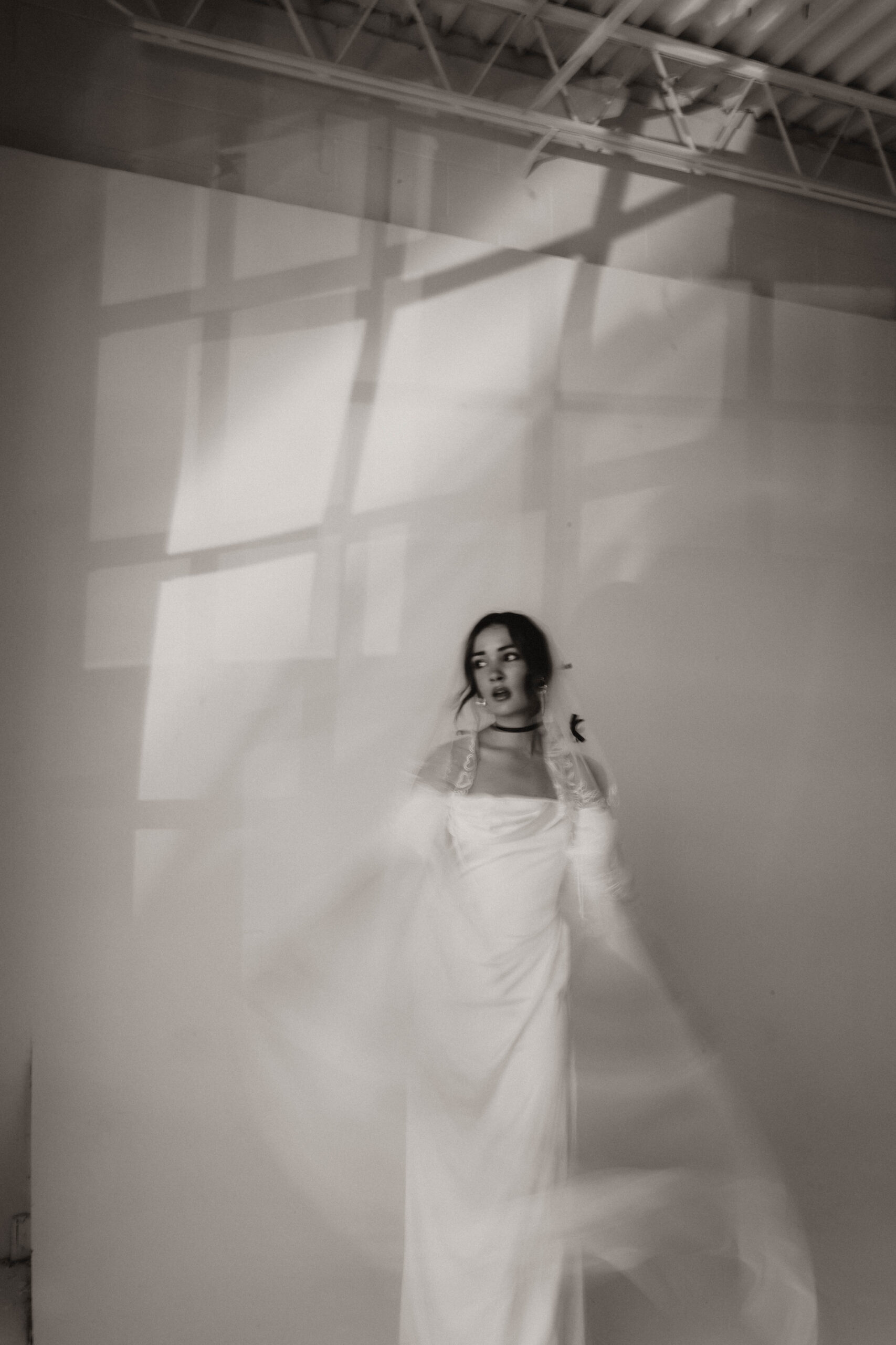 studio bridal photography of bride moving her veil 