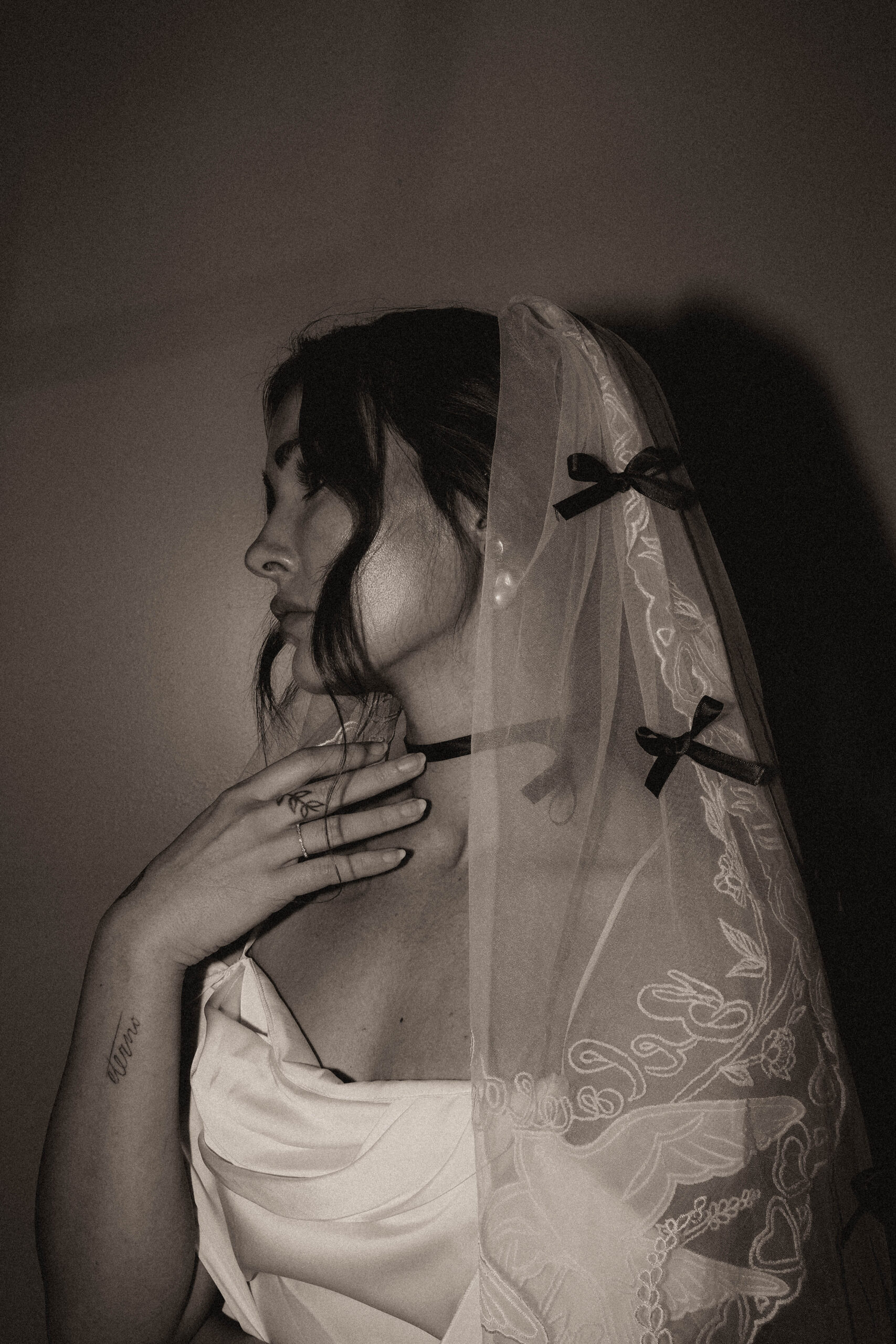 black and white flash photo of bride and her veil 