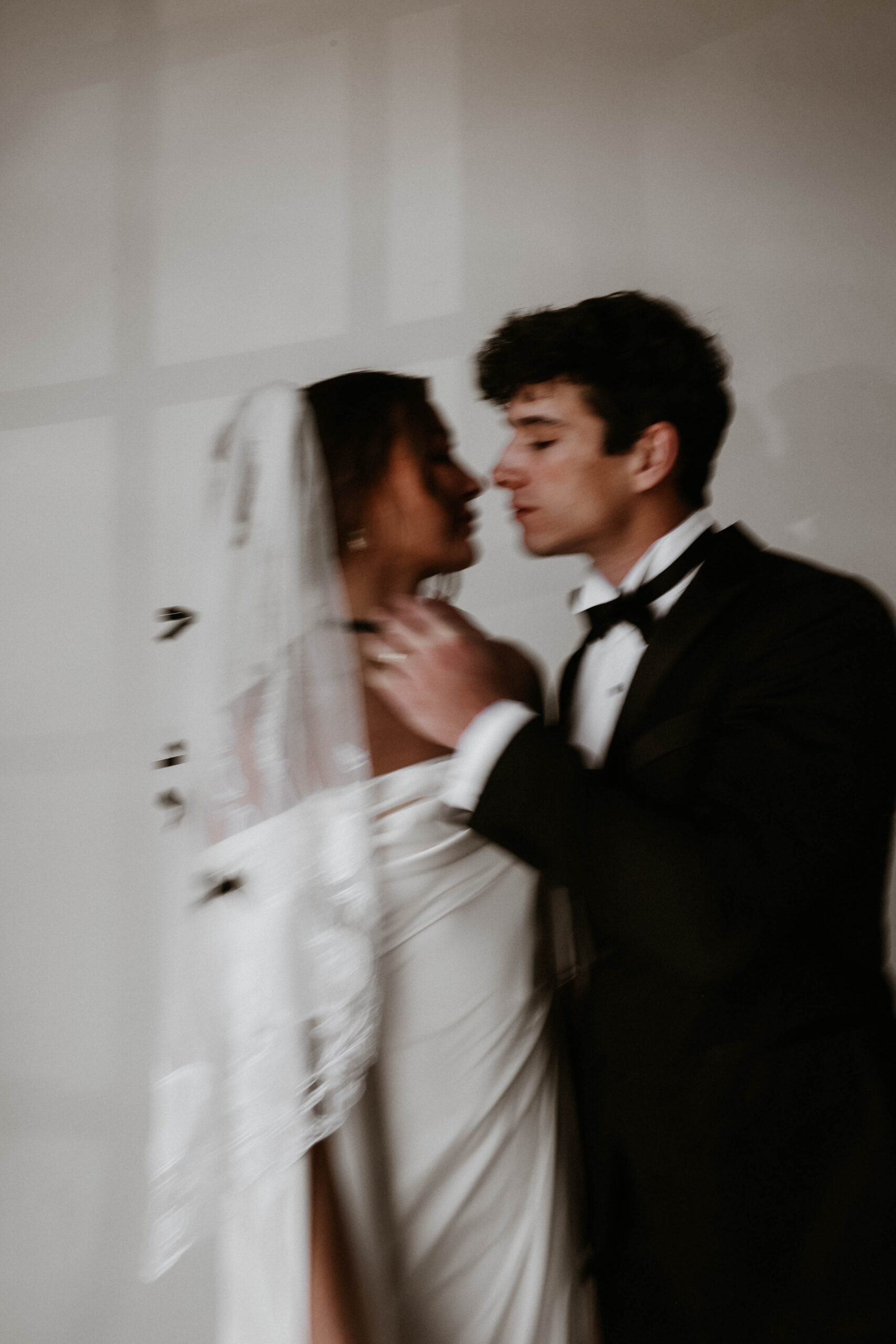 blurry studio bridal of bride and groom about to kiss 