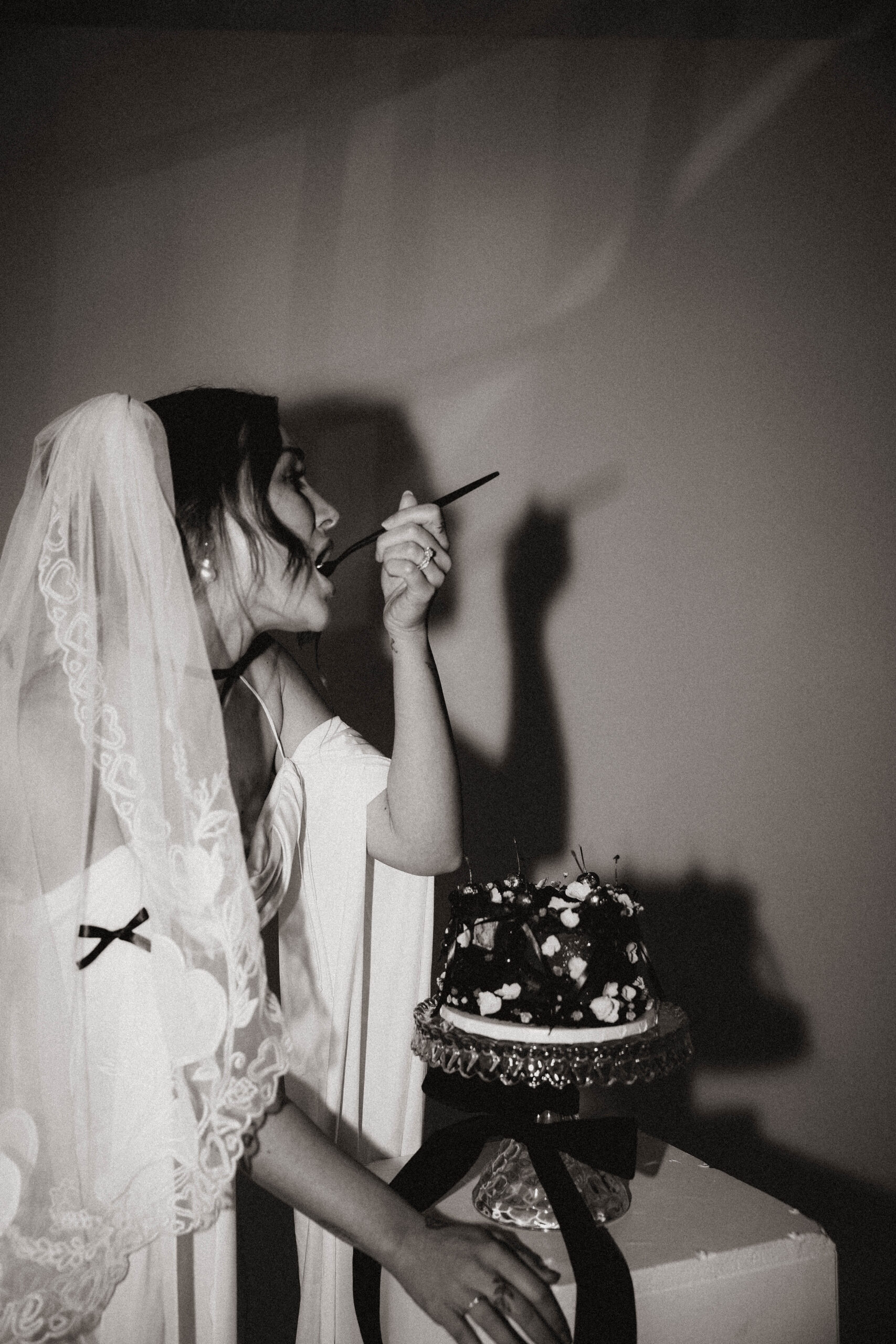 bride taking a bite of the cake