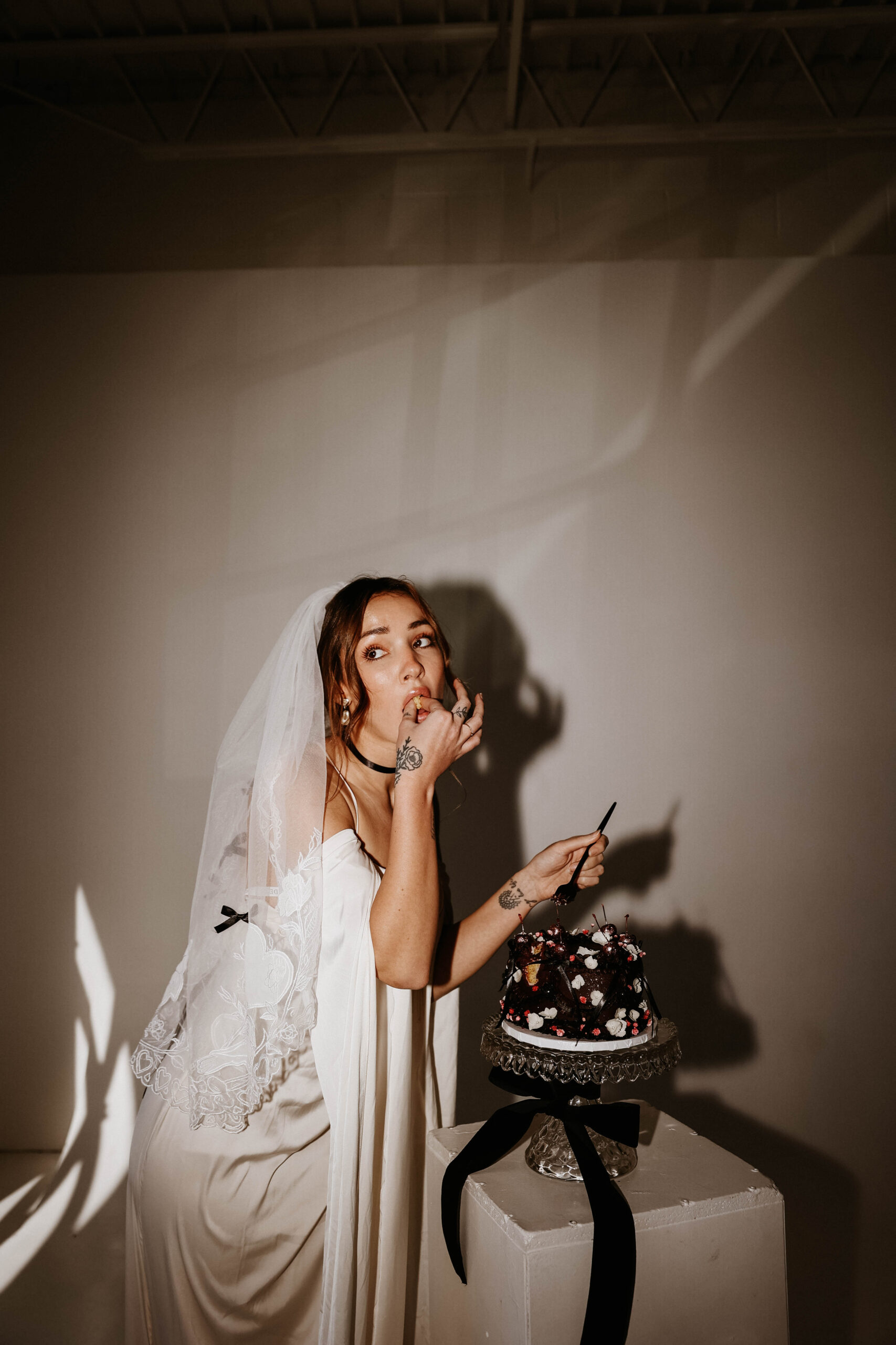 flash photo of bride eating cake 