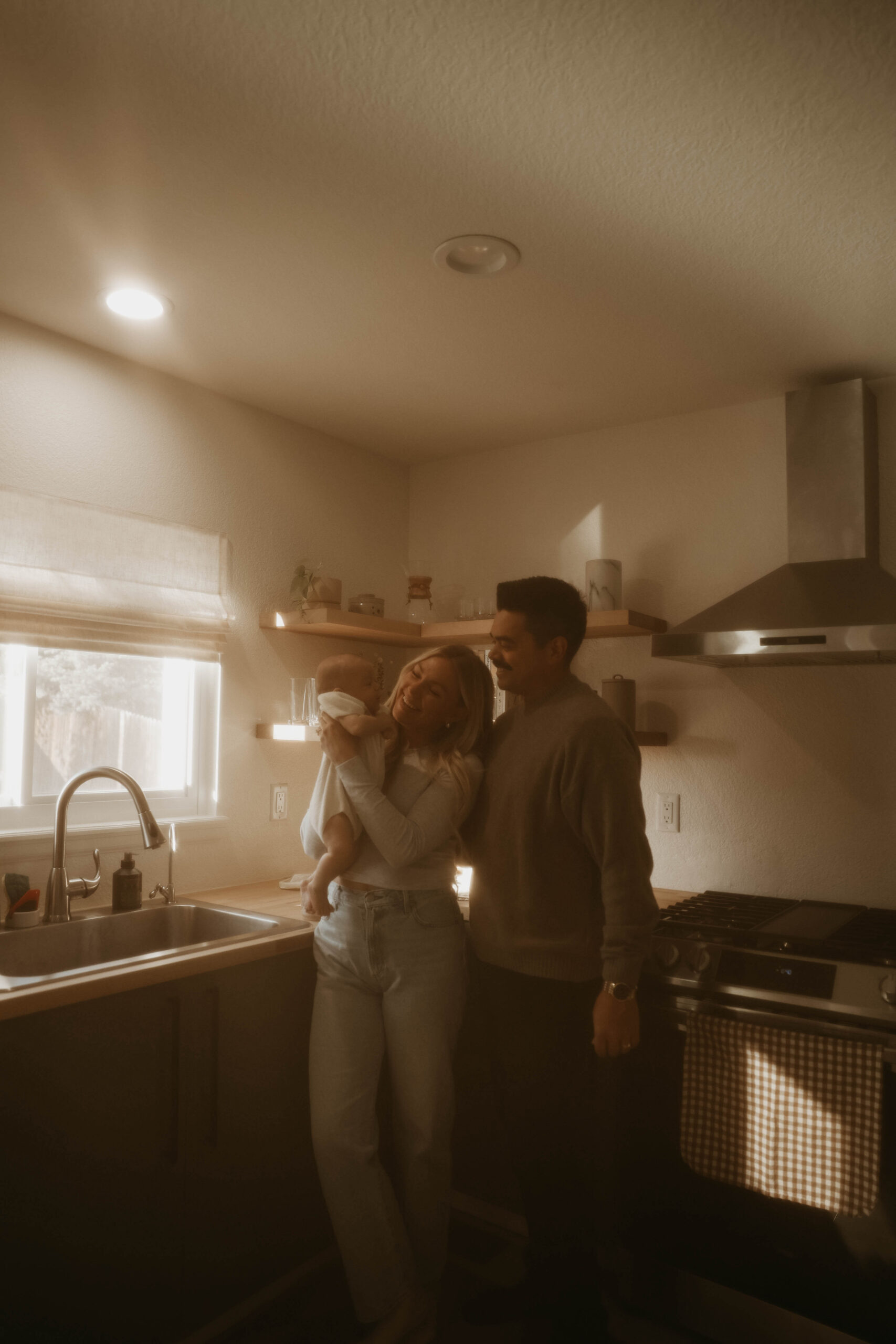 a family standing in their kitchen during in-home family photos 