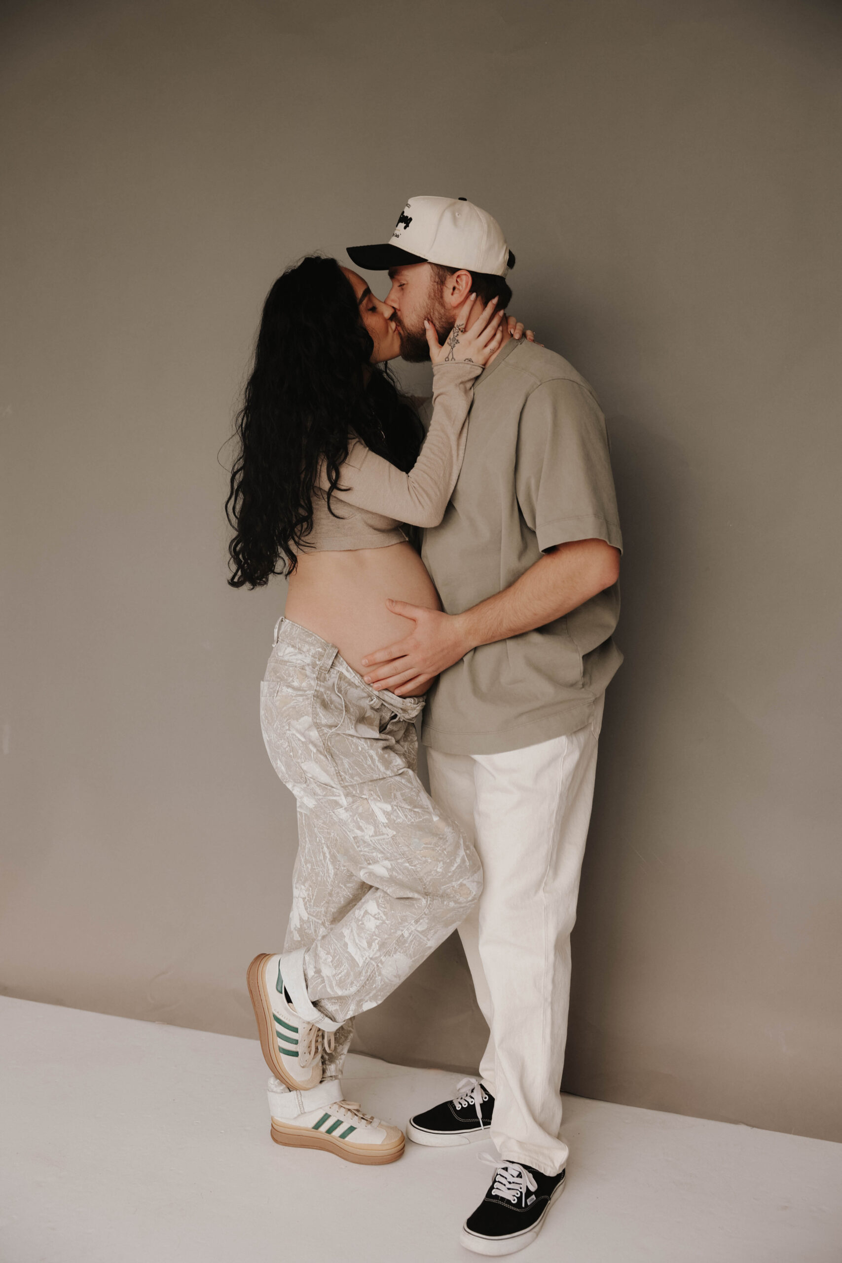 couple kissing during studio maternity session