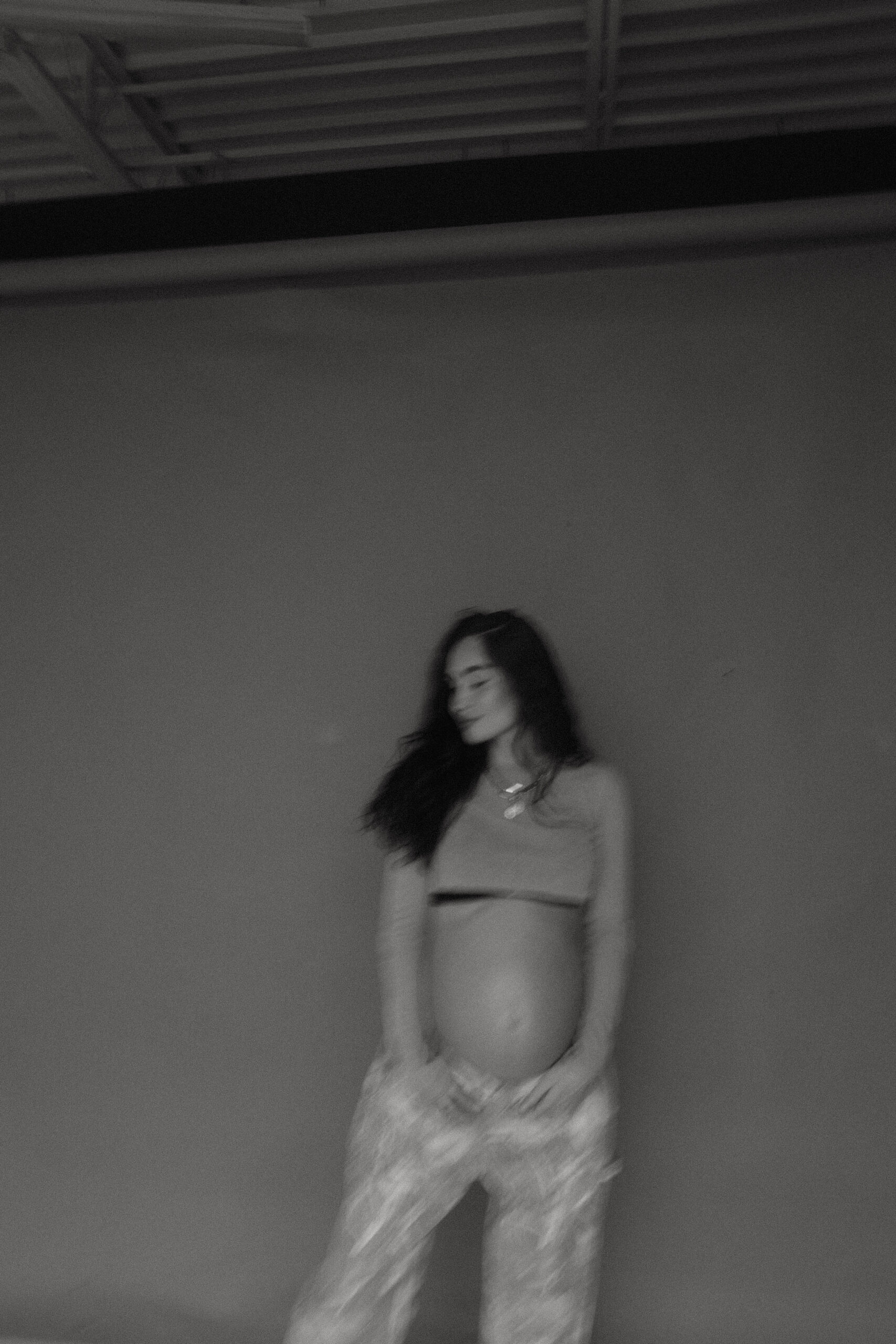 blurry image of a pregnant woman in studio