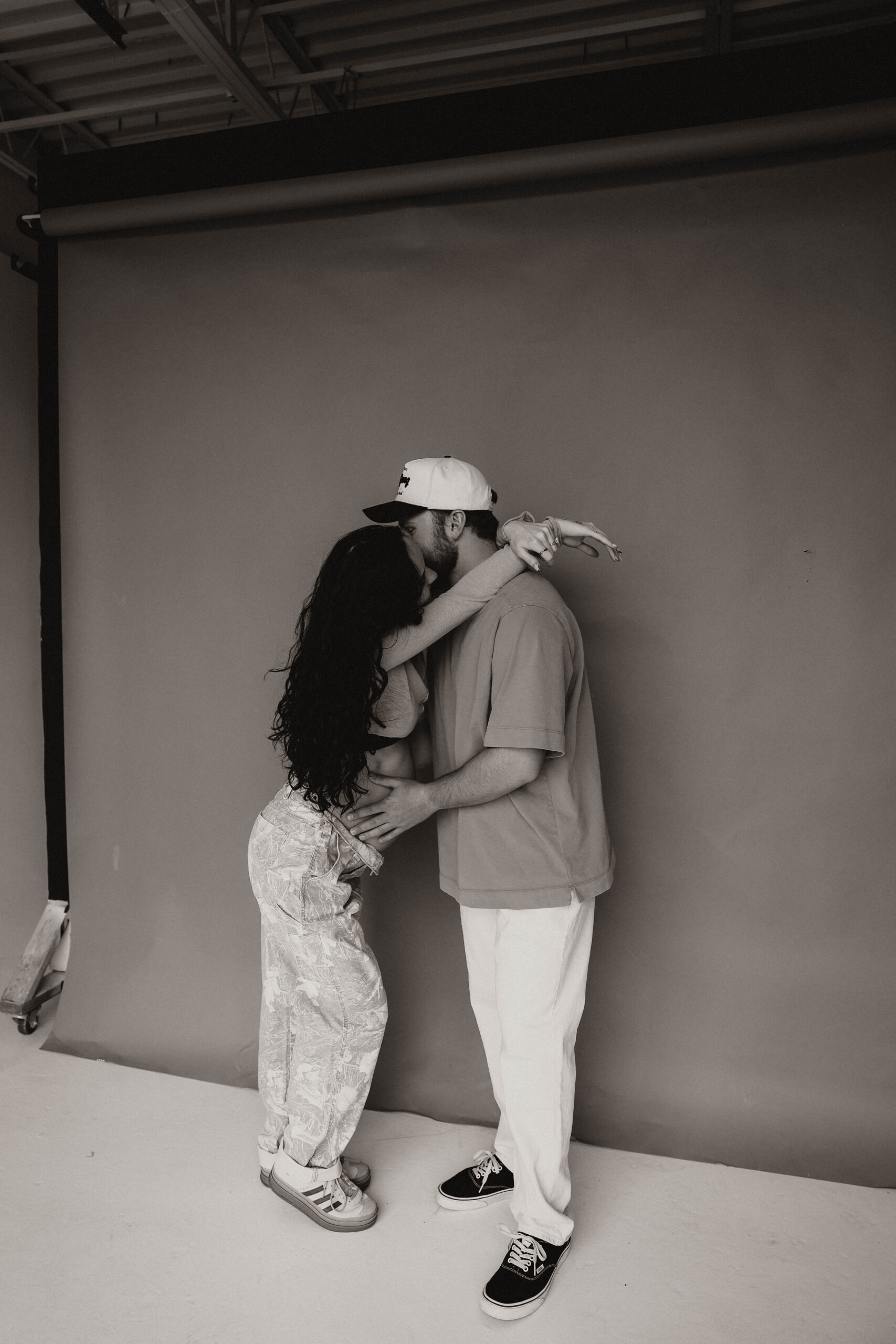 couples holding each other in studio during denver maternity photoshoot