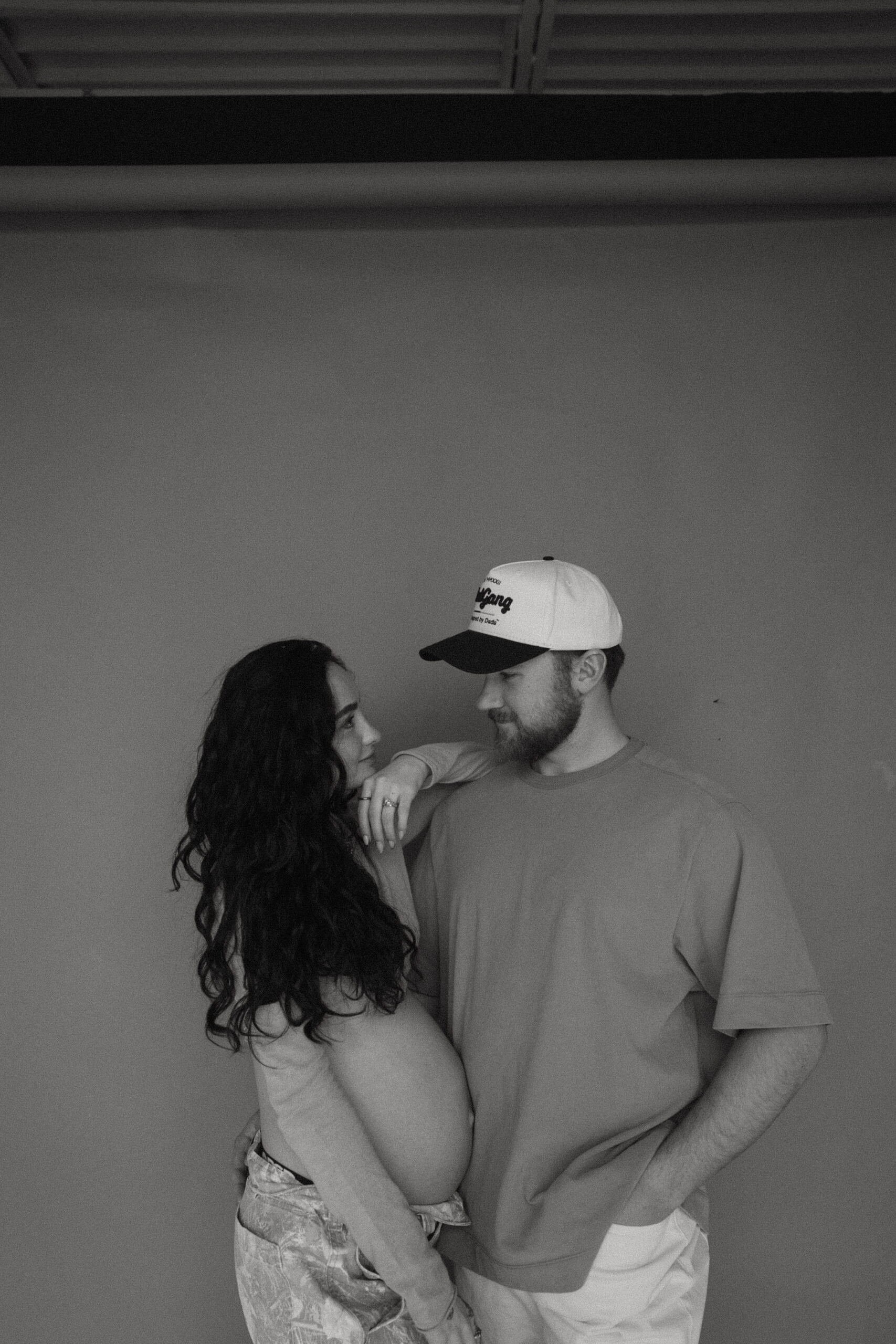 soon to be parents looking at each other during denver maternity photoshoot