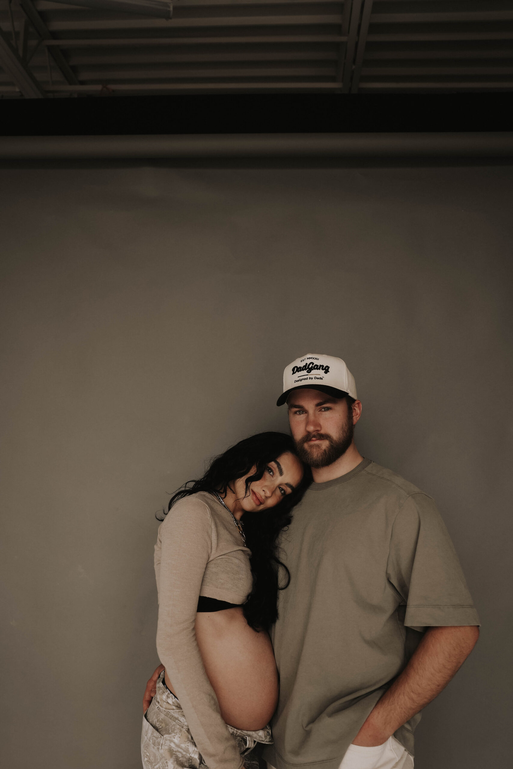 soon to be mama resting her head on dad's shoulder for denver maternity photoshoot