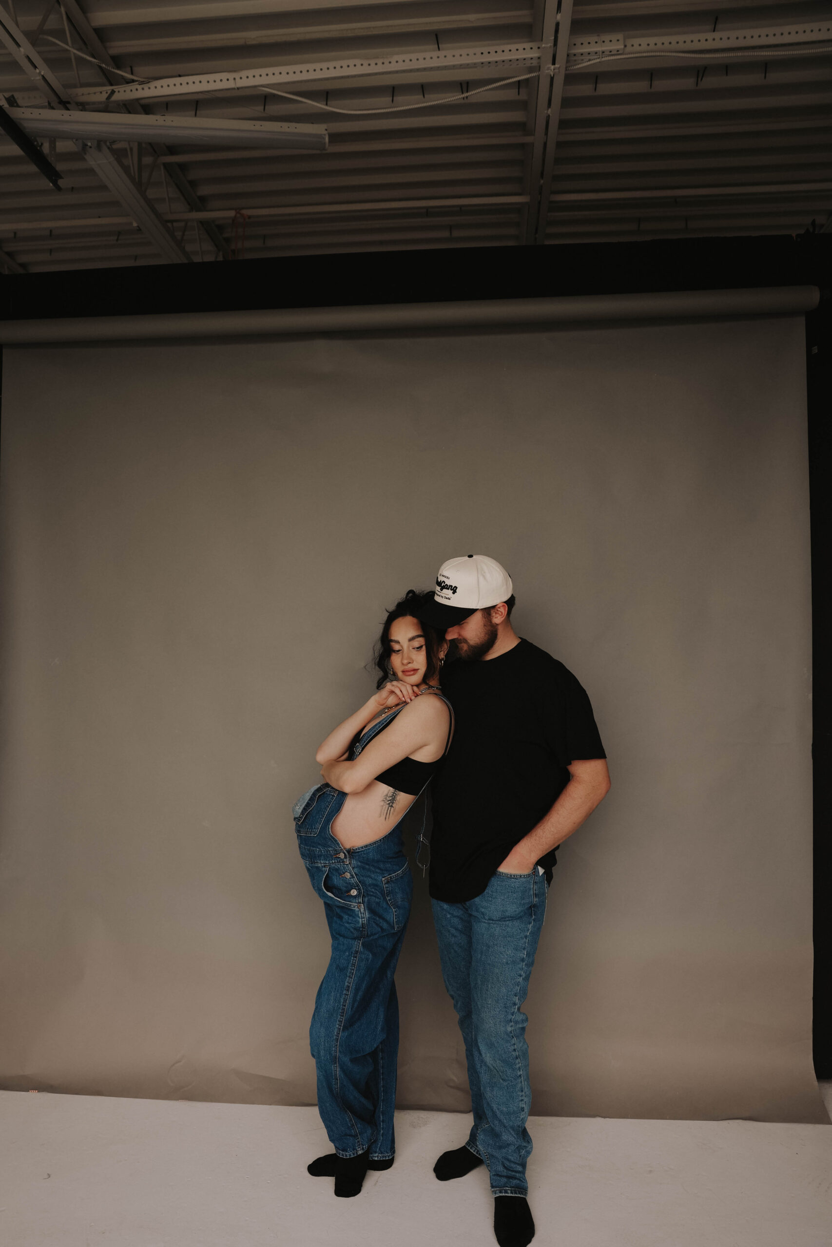 mama leaning against soon to be dad during denver maternity photoshoot