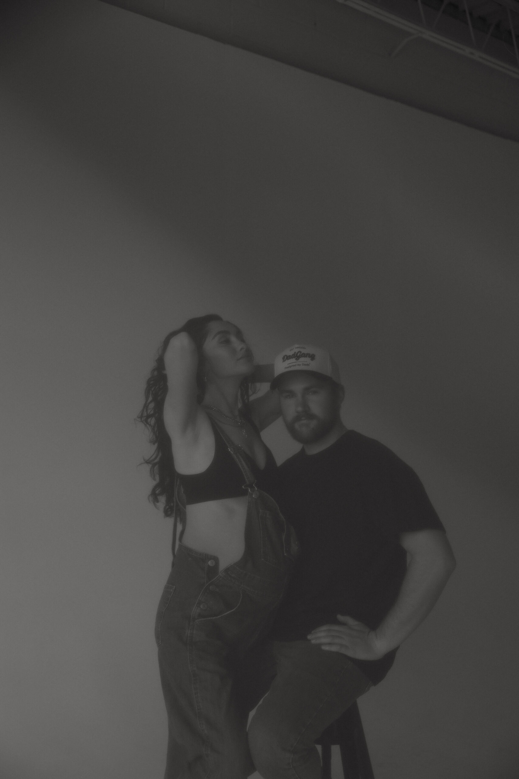 soon to be parents posing in studio during denver maternity photoshoot